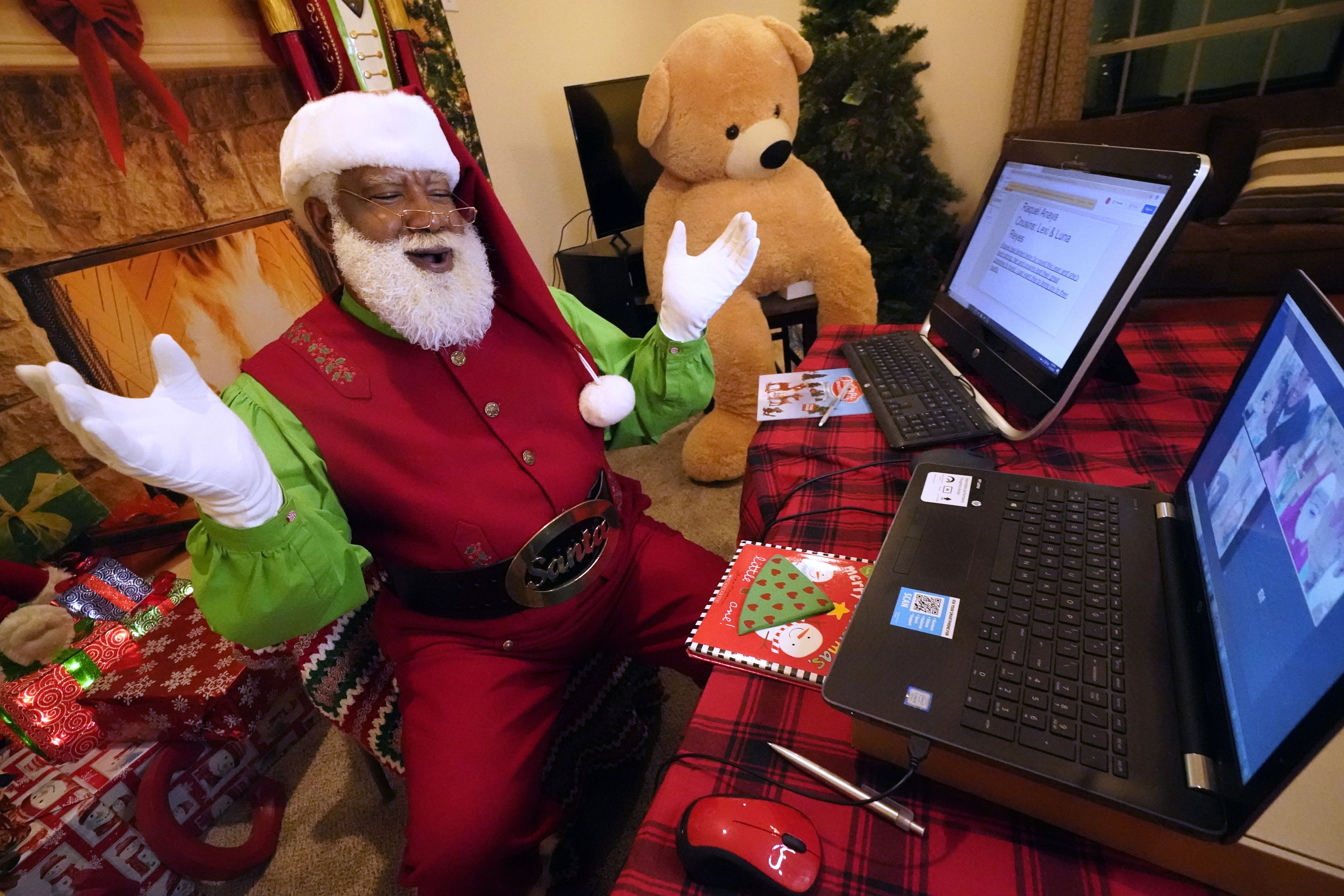 Larry Jefferson as Santa Claus livestreams with families during the COVID-19 pandemic