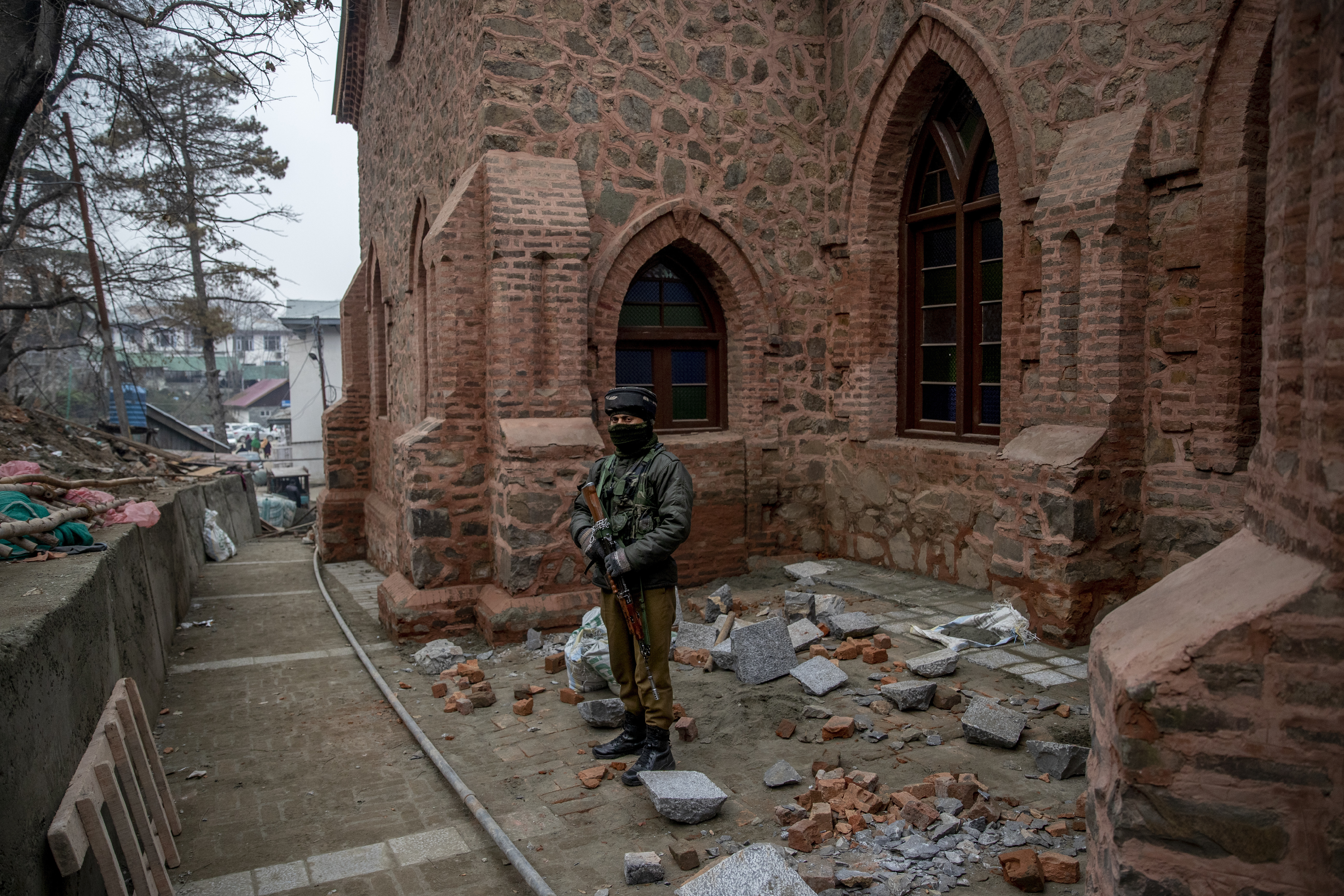 An Indian paramilitary soldier stands guard outside a newly renovated St Luke's Church during Christmas celebrations in Srinagar, Indian controlled Kashmir, Saturday, Dec. 25