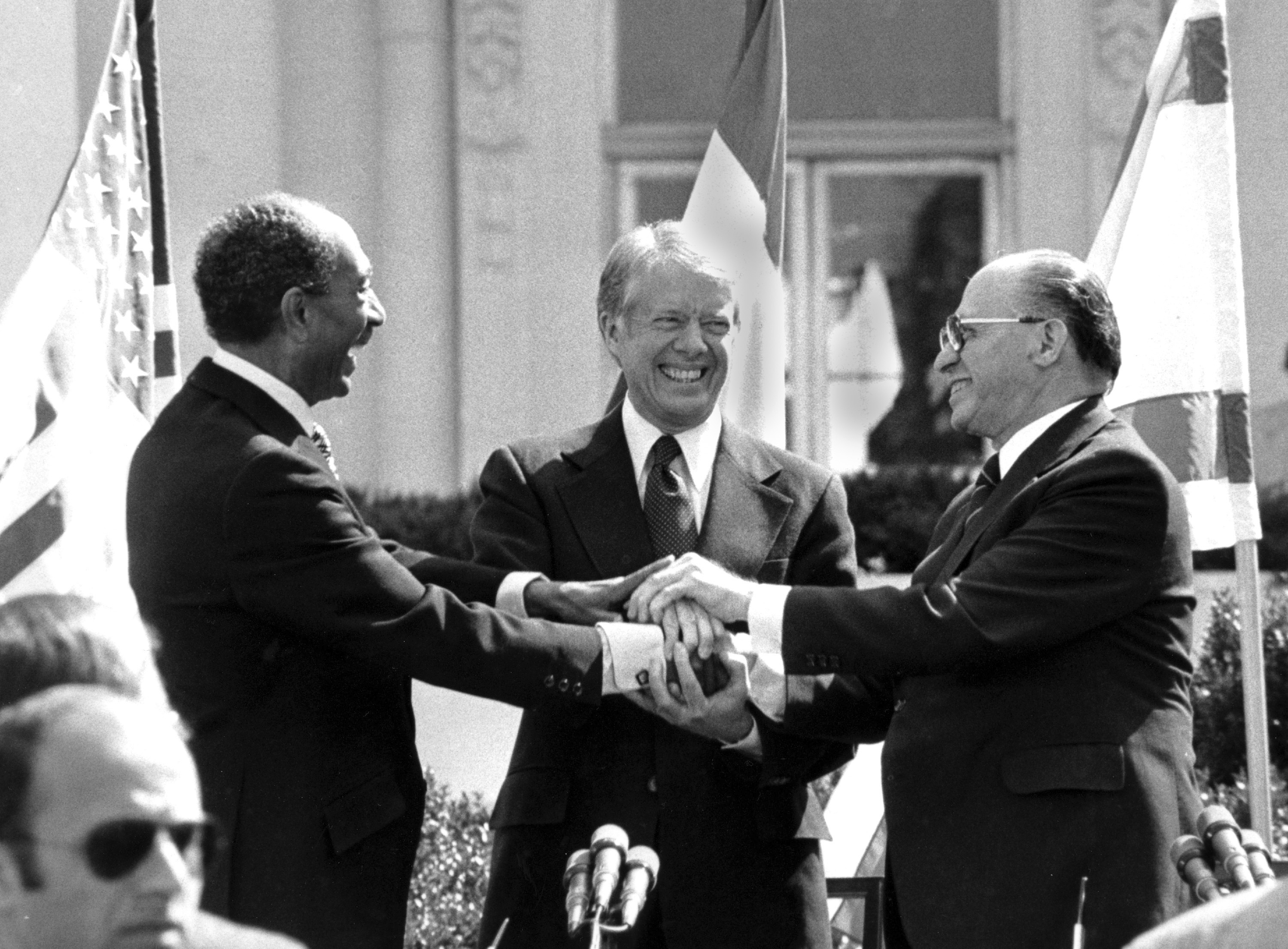 FILE - Egyptian President Anwar Sadat, left, U.S. President Jimmy Carter, center, and Israeli Prime Minister Menachem Begin clasp hands on the north lawn of the White House after signing the peace treaty between Egypt and Israel, March 26, 1979, in Washington. (AP Photo/Bob Daugherty, File)