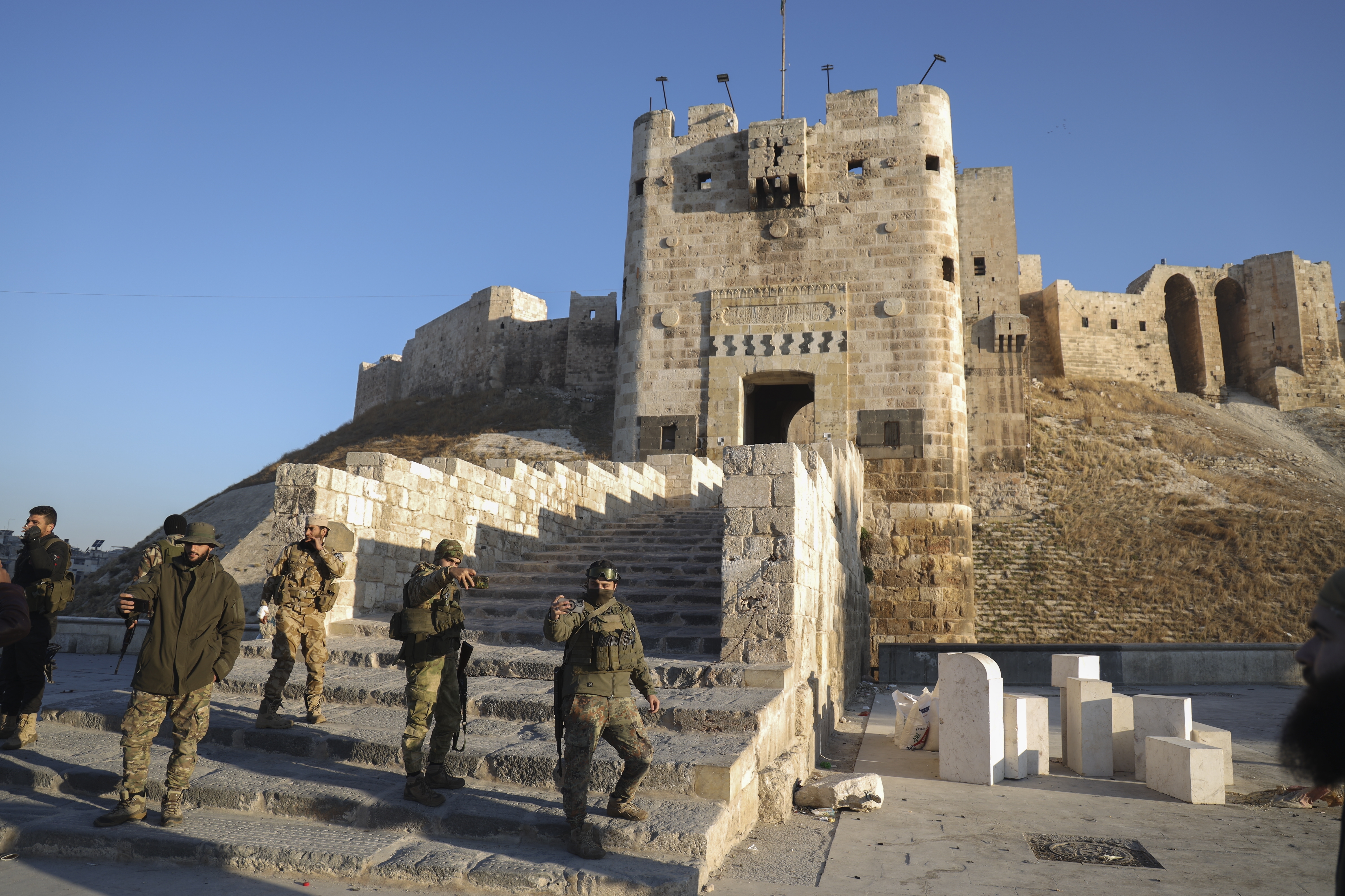 Fighters gather near the old city in Aleppo