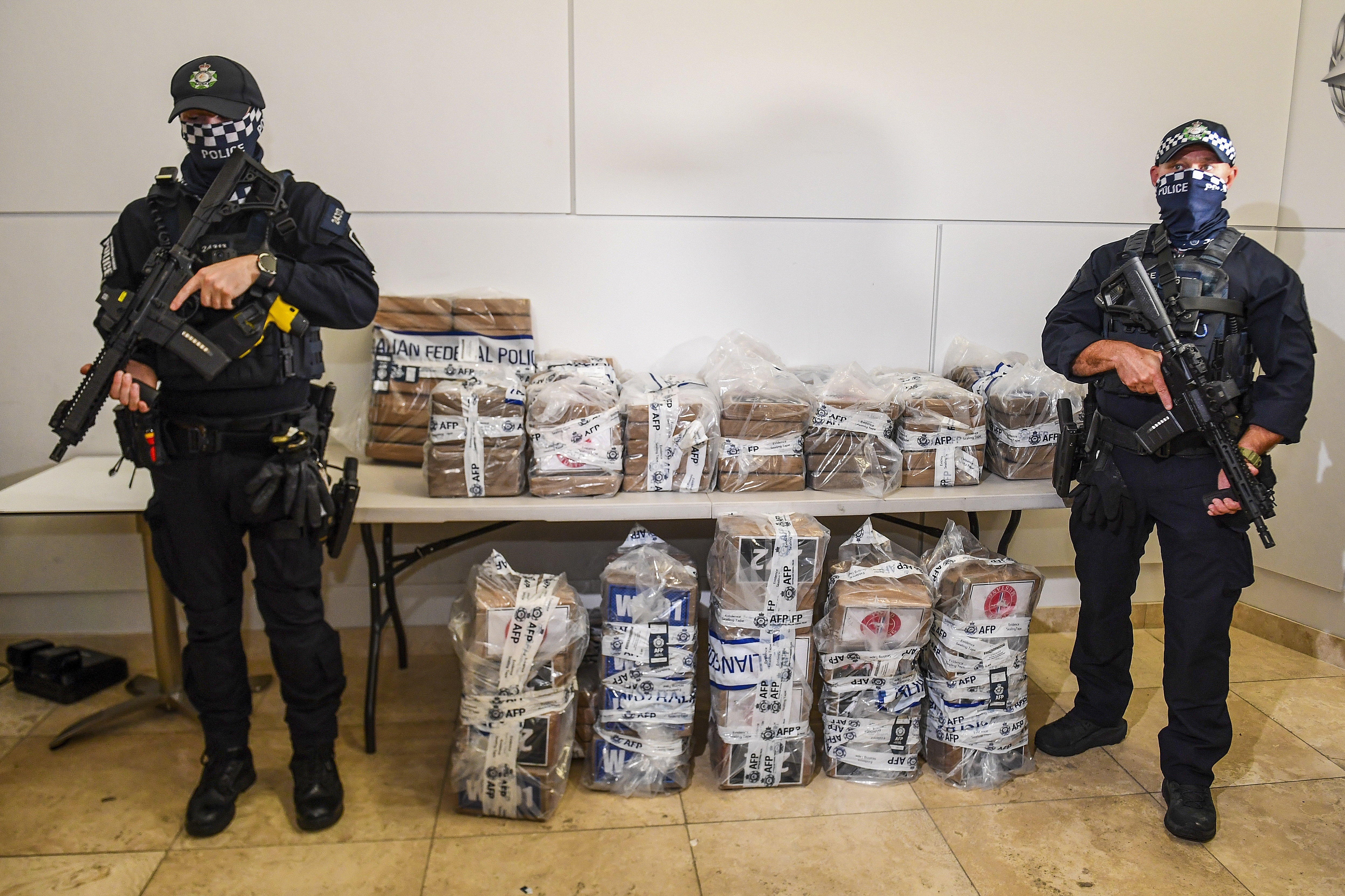 Australian Federal Police officers pose with seized cocaine in Brisbane