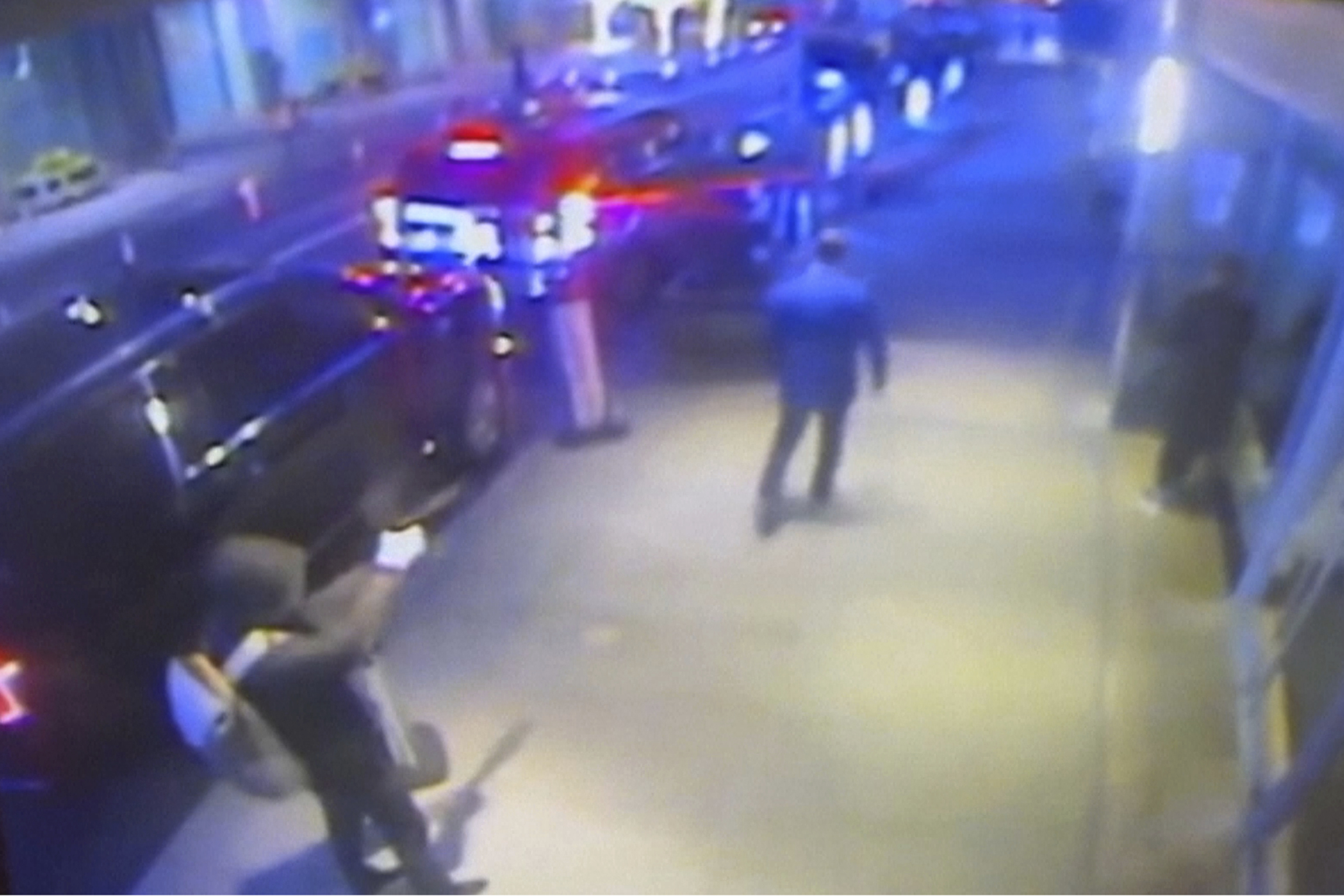 This still image from surveillance video obtained by the Associated Press shows the suspect, left, sought in the the killing of UnitedHealthcare CEO Brian Thompson