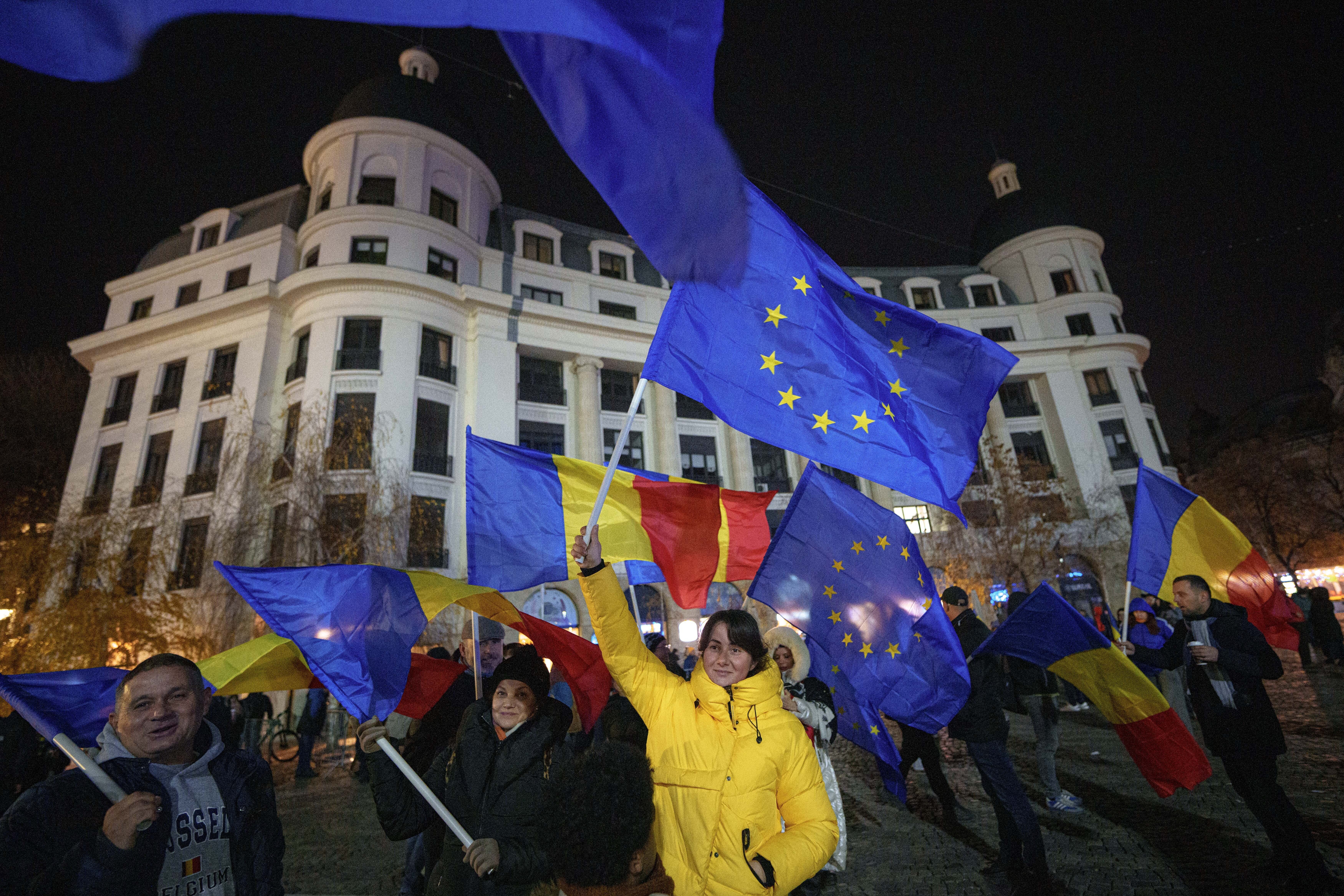 People wave Romanian and European Union flags during a pro-EU rally