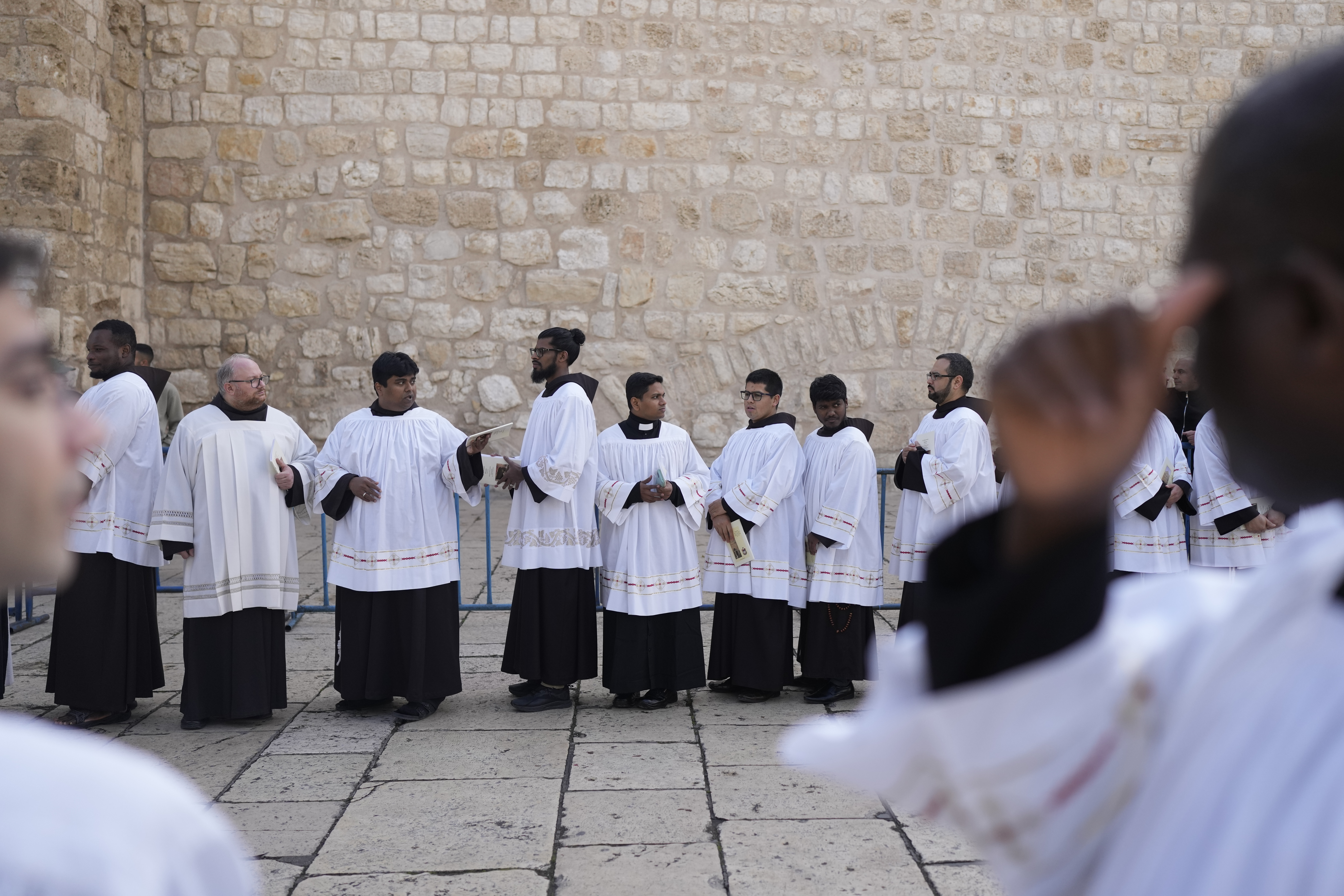Clergymen wait for Latin Patriarch Pierbattista Pizzaballa to enter the Church of the Nativity, traditionally believed to be the birthplace of Jesus, on Christmas Eve, in the West Bank city of Bethlehem, Tuesday, Dec. 24