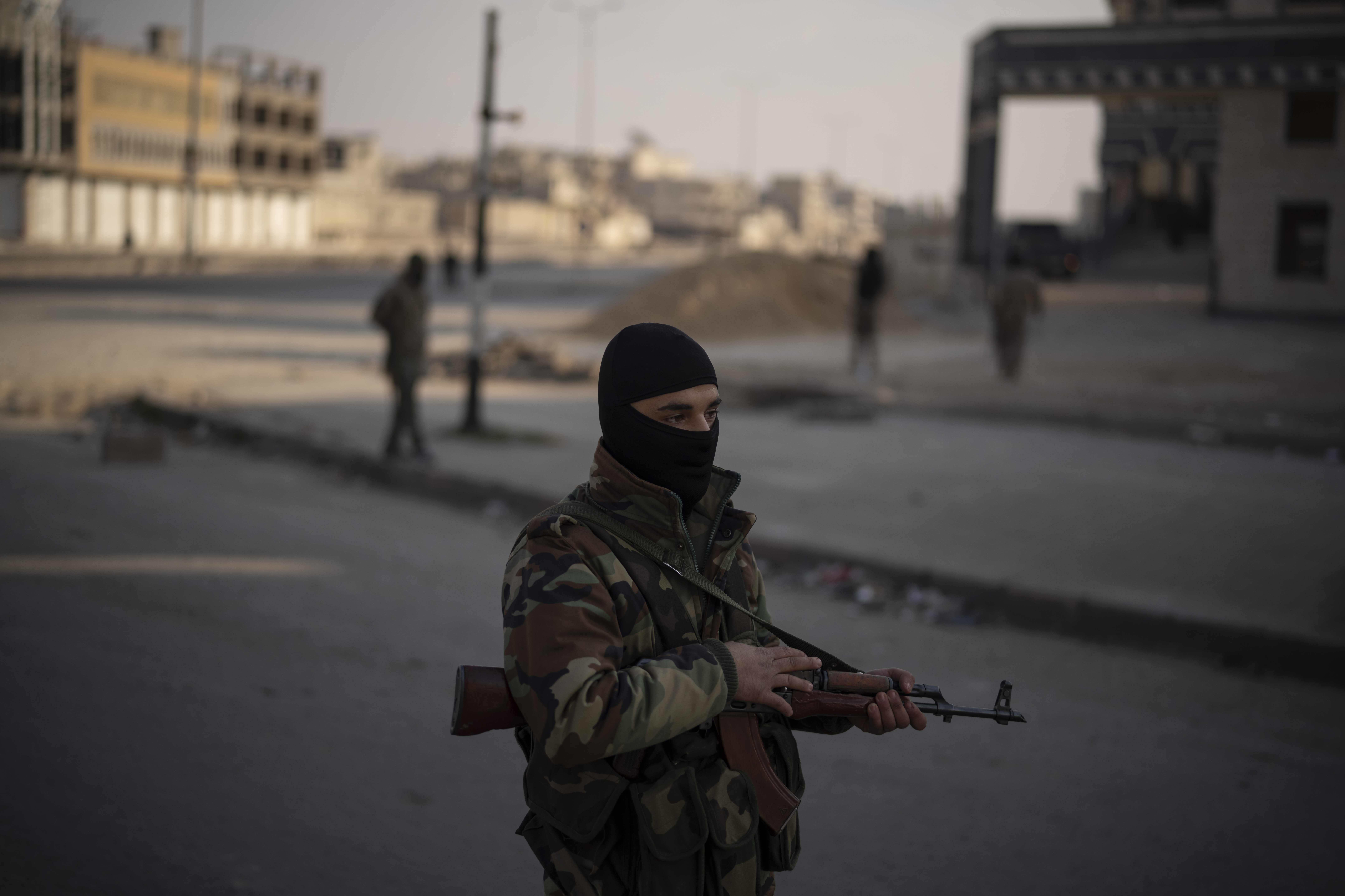A member of the security forces of the newly formed Syrian government stands on guard at a security checkpoint, in Homs, Syria, Thursday, Dec. 26