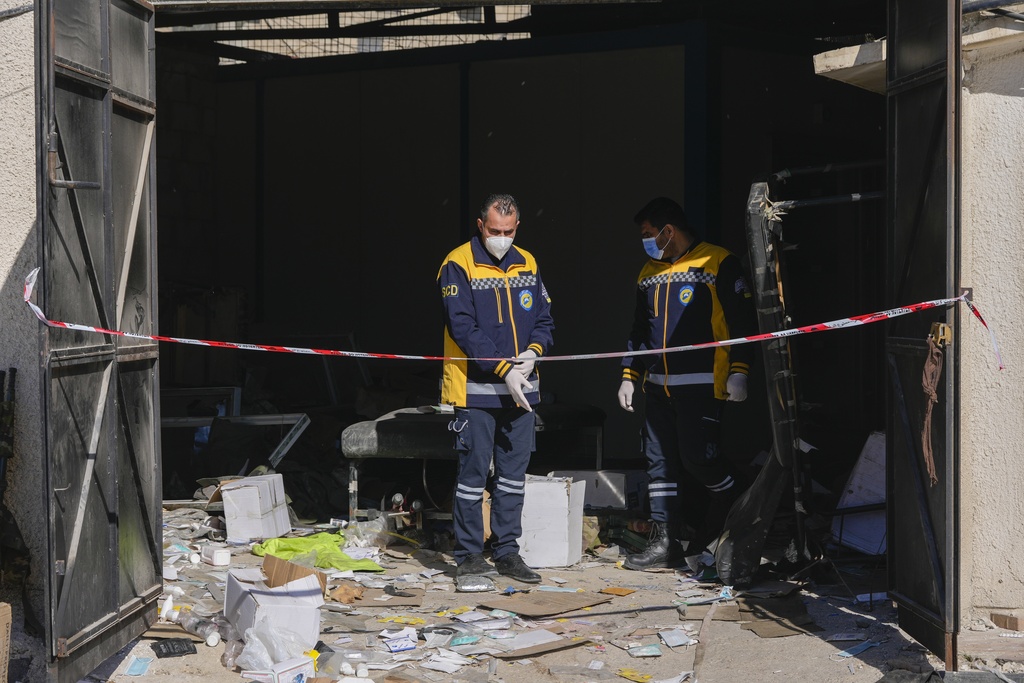 A Syrian civil defense team, known as the White Helmets, inspects a morgue, previously used by pro-government Iranian units, located near the Set Zainab shrine, south of Damascus, Syria, on Wednesday, Dec. 18, 2024 (AP Photo/Hussein Malla)