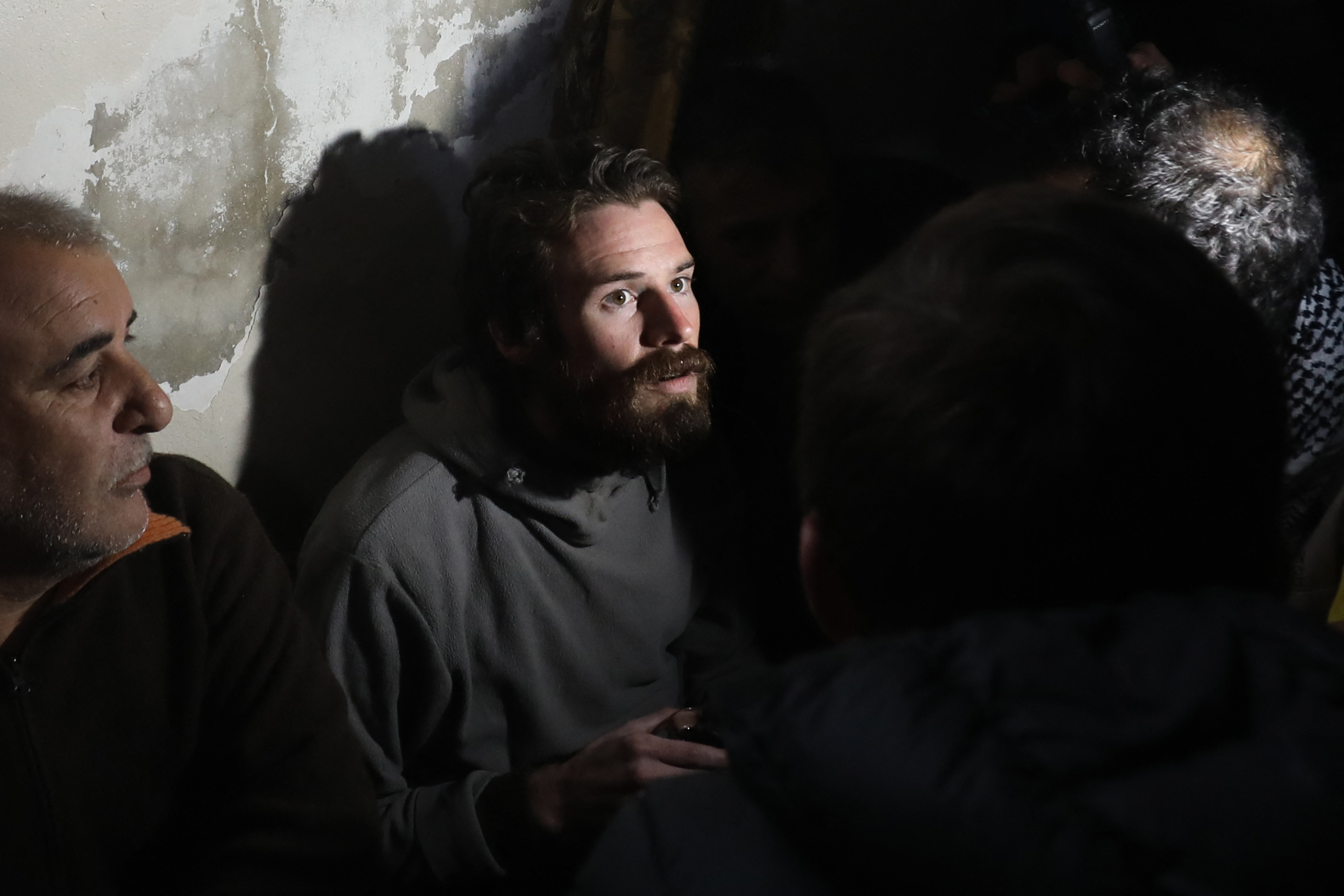 Travis Timmerman, a US citizen who had entered Syria from Lebanon on a Christian pilgrimage and had been detained for several months, speaks with reporters in a house in Damascus on December 12, 2024, after he was found in the village of Thihabiyeh east of the capital, after rebels toppled longtime president Bashar al-Assad. (Photo by Abdulaziz KETAZ / AFP)