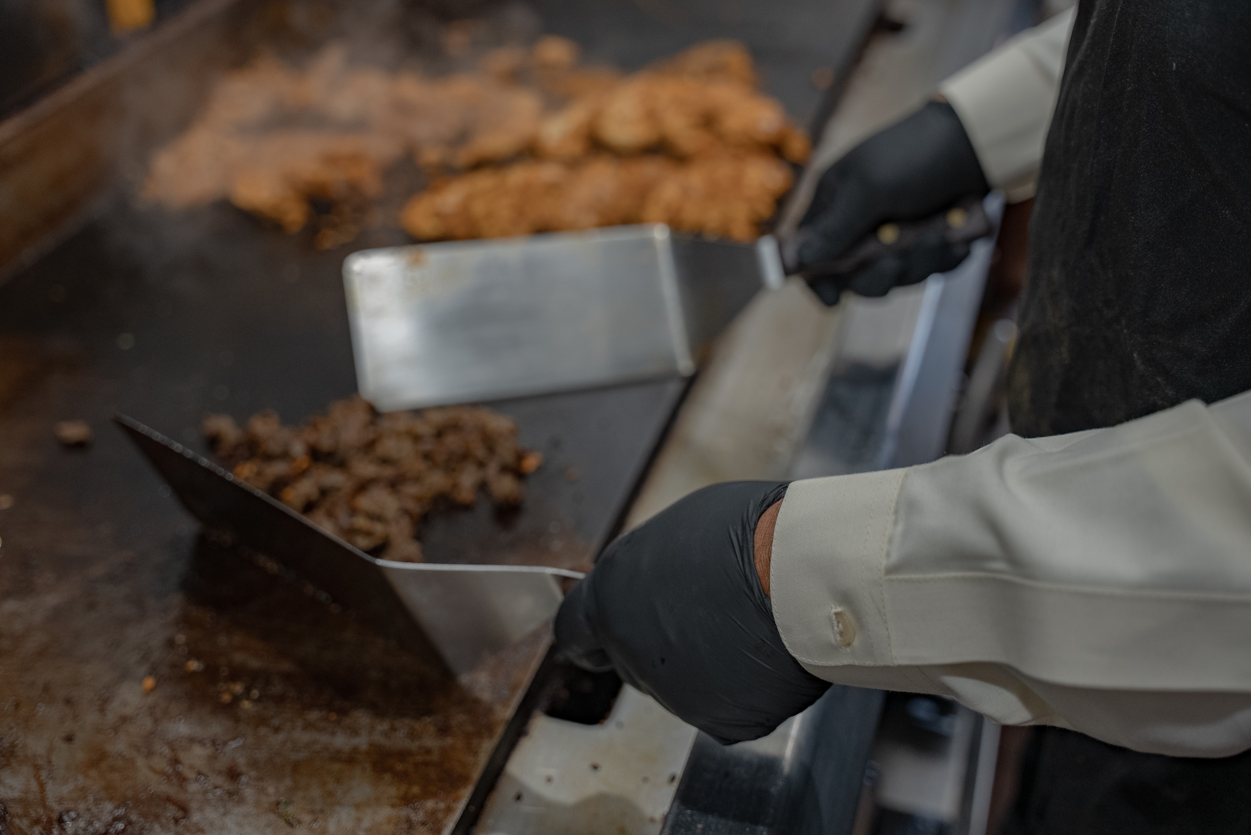 Close up of meat cooking on a griddle