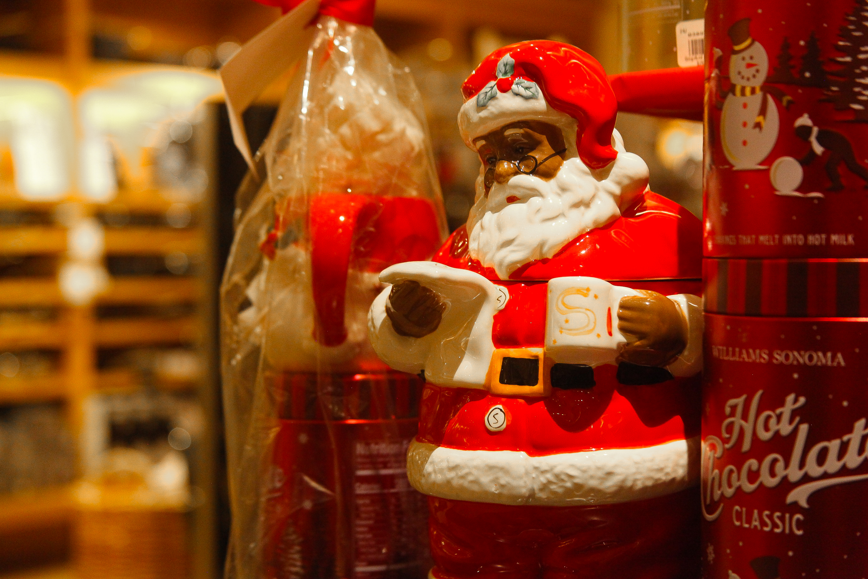 A Santa Claus cookie jar on a store shelf