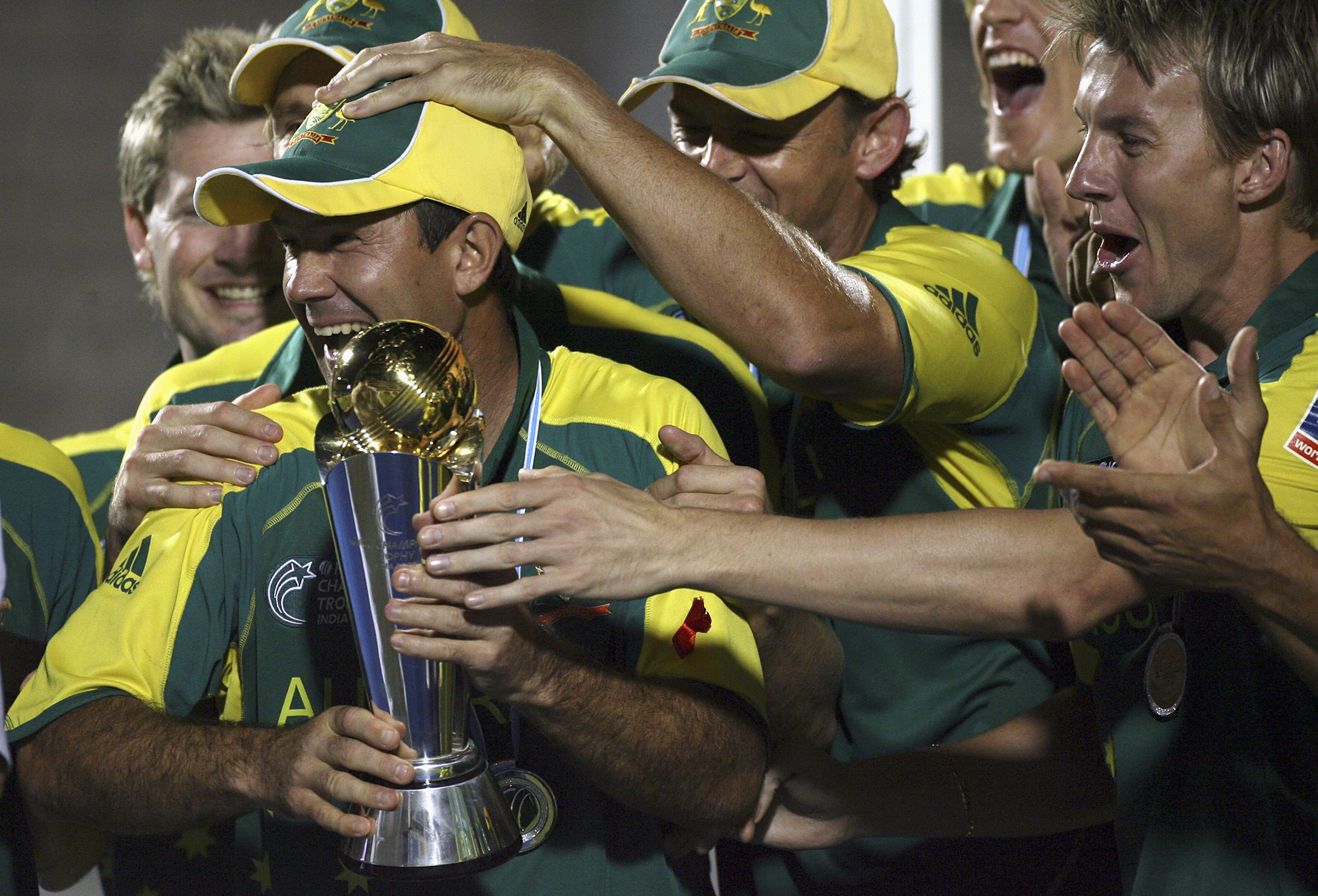 Australian players hold the ICC champions trophy during the award ceremony after Australia beat West Indies in Mumbai November 5, 2006. REUTERS/Adnan Abidi (INDIA)