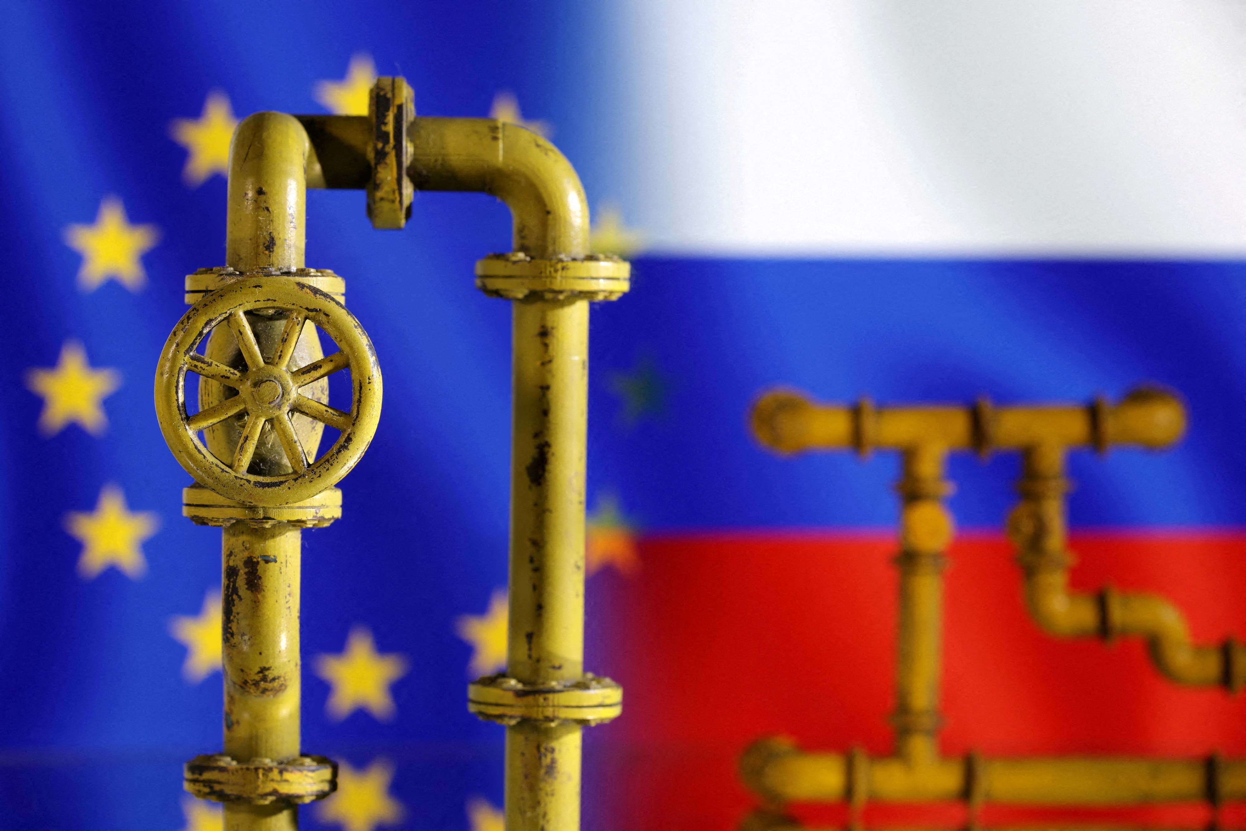 Model of natural gas pipeline, EU and Russia flags, July 18, 2022.