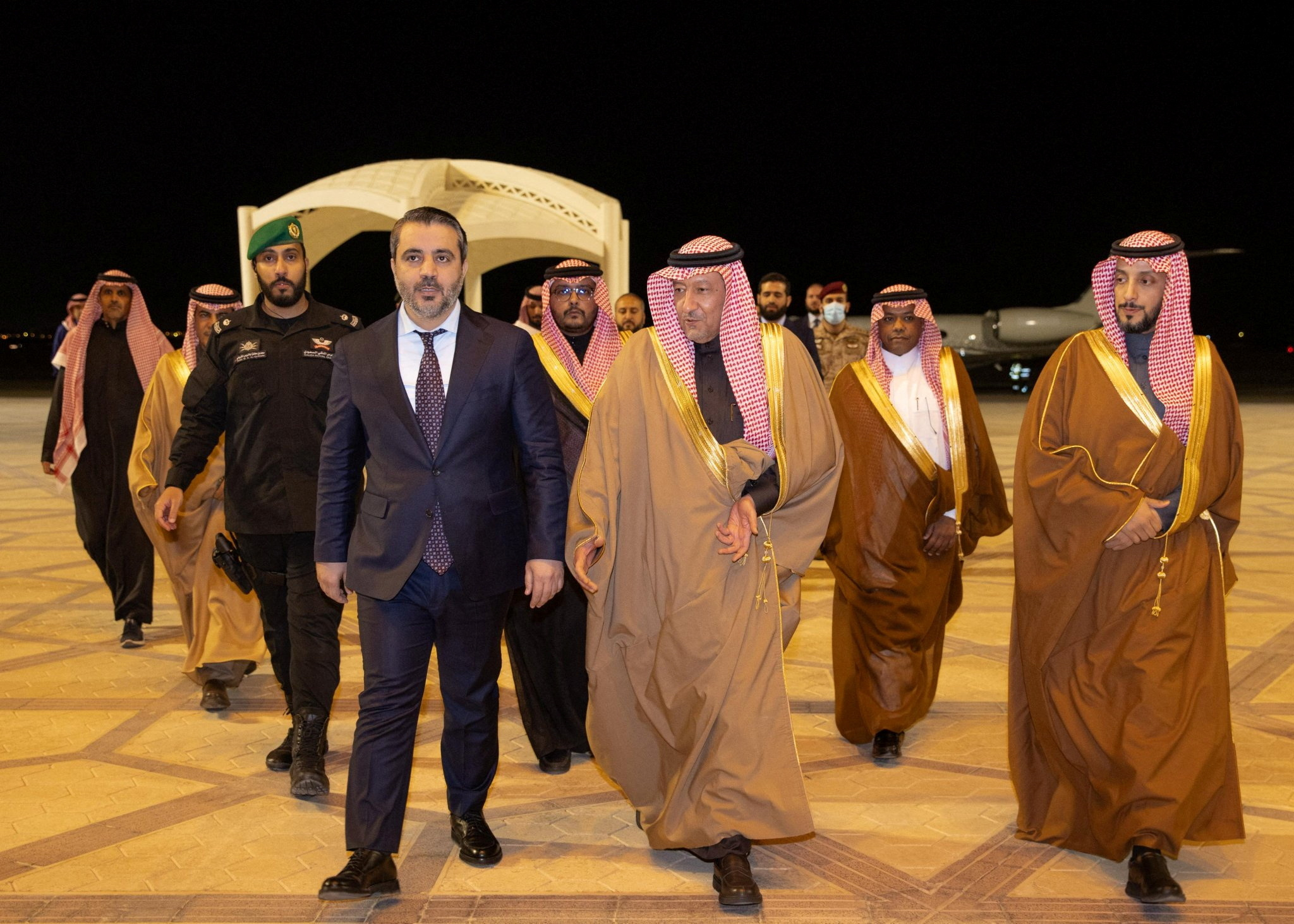 Syria's newly appointed Foreign Minister Asaad Hassan al-Shibani walks with Saudi Deputy Foreign Minister Waleed Elkhereiji as he is welcomed upon his arrival in Riyadh, Saudi Arabia, January 1, 2025