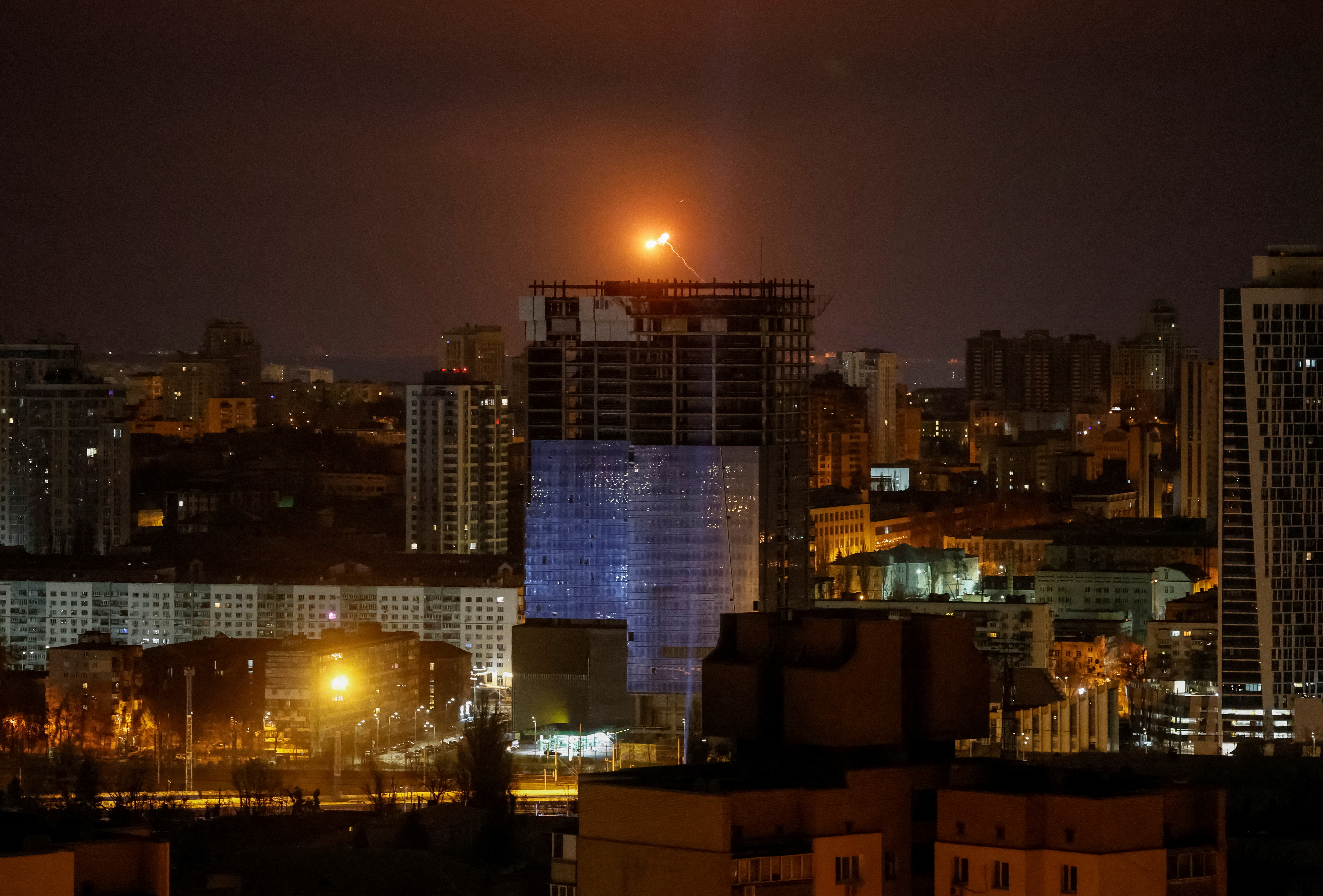 An explosion of a drone is seen in the sky over the city during a Russian drone strike, amid Russia's attack on Ukraine, in Kyiv.