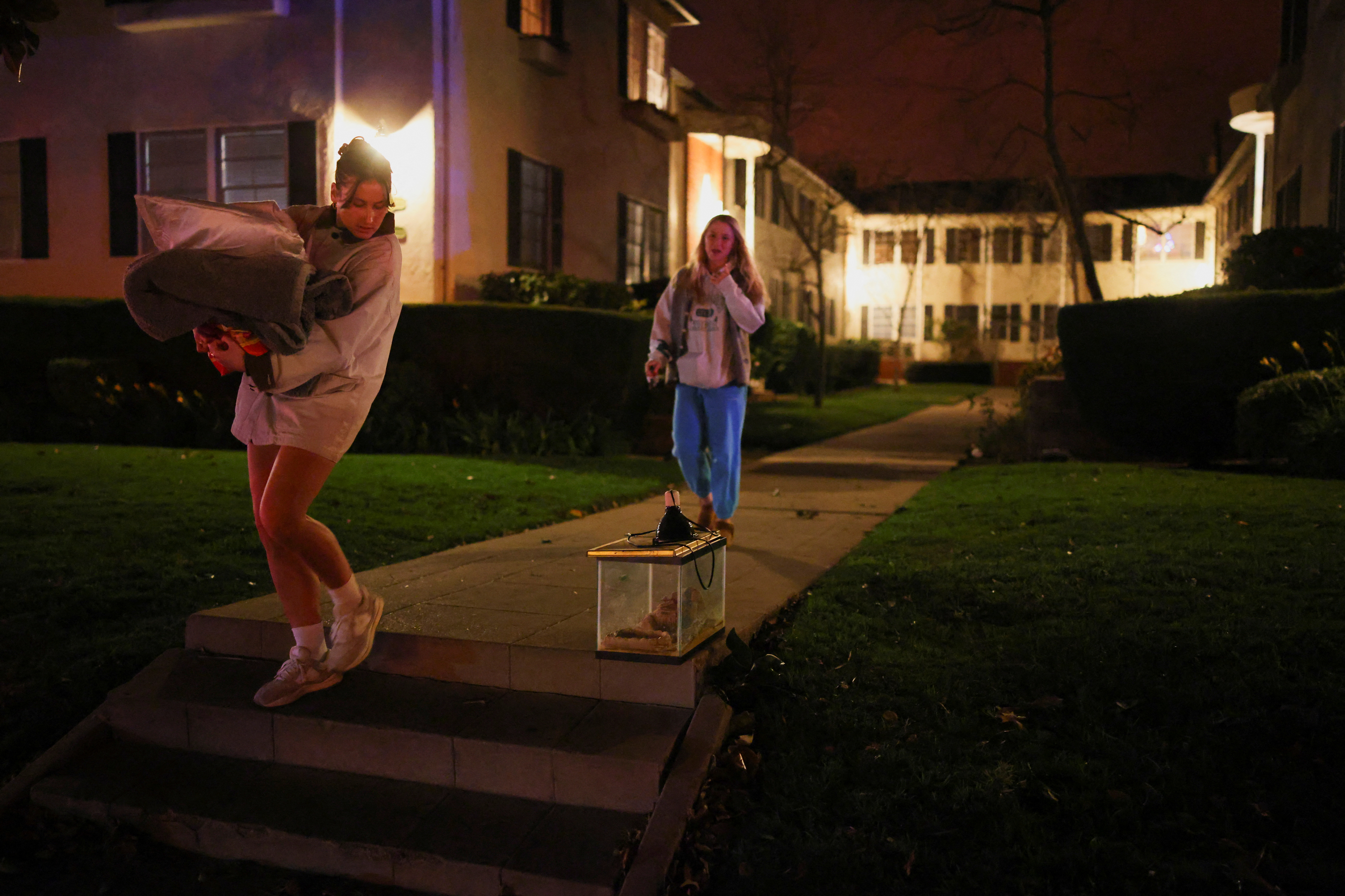 People leave following an evacuation order, as a wildfire burns in the Pacific Palisades neighborhood of west Los Angeles, in Santa Monica, California