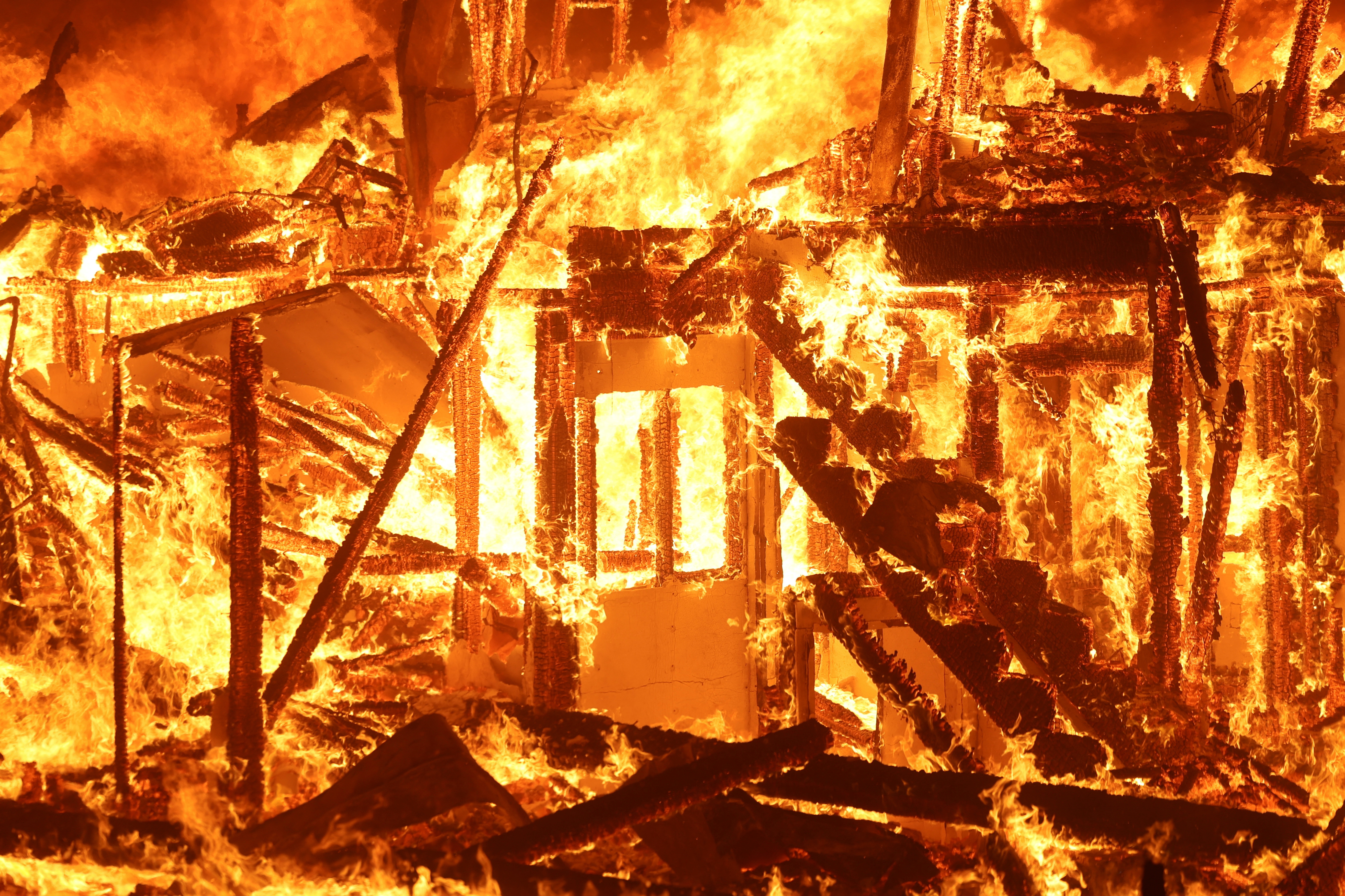 Flames engulf a structure as the Eaton Fire burns in Pasadena, California, U.S. January 7