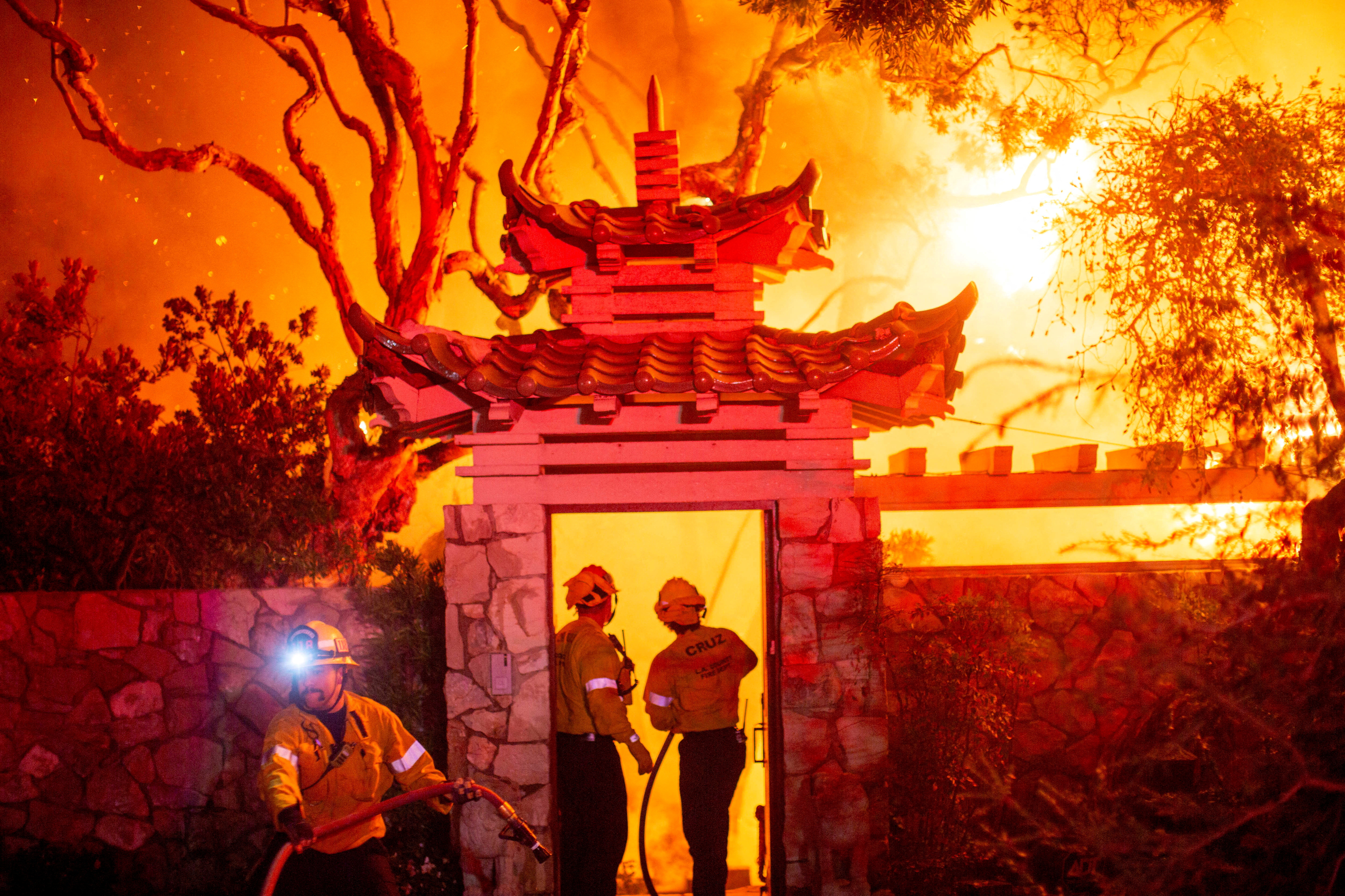 Firefighters battle the Palisades Fire as it burns during a windstorm on the west side of Los Angeles, California, U.S. January 8