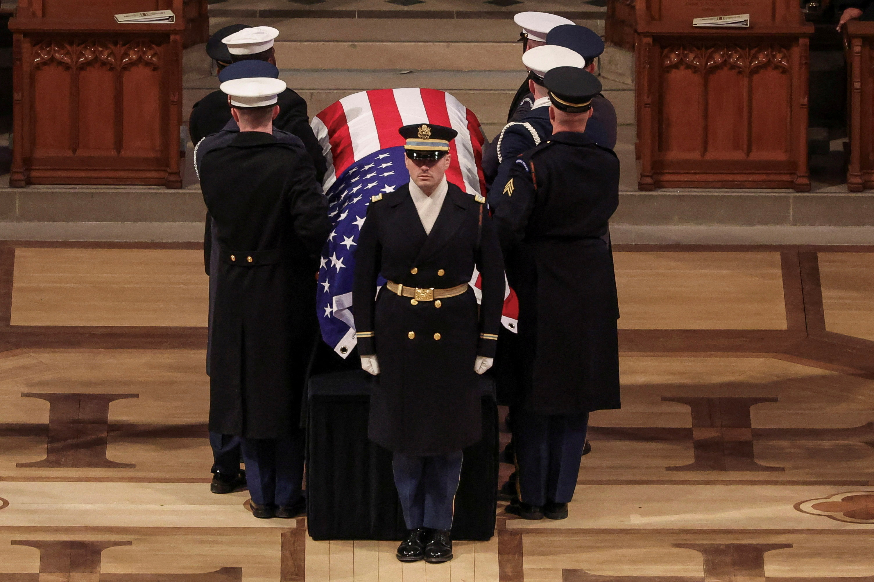 Service members carry Jimmy Carter's casket