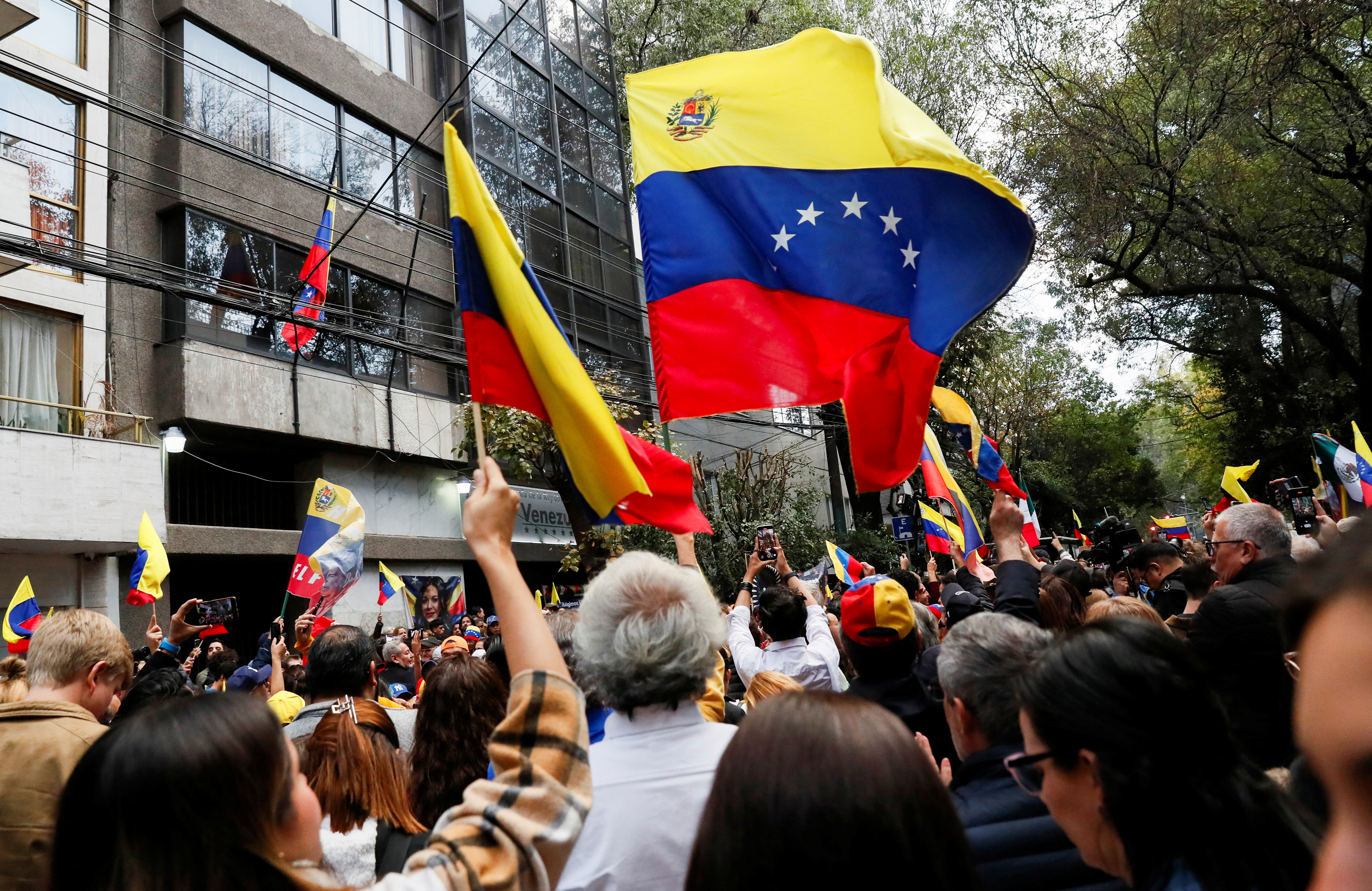 People and Venezuelans living in Mexico gather in support of the country's opposition and take part in a demonstration outside Venezuela's embassy, a day before Venezuelan President Nicolas Maduro is set to be inaugurated for his third term, in Mexico City, Mexico January 9