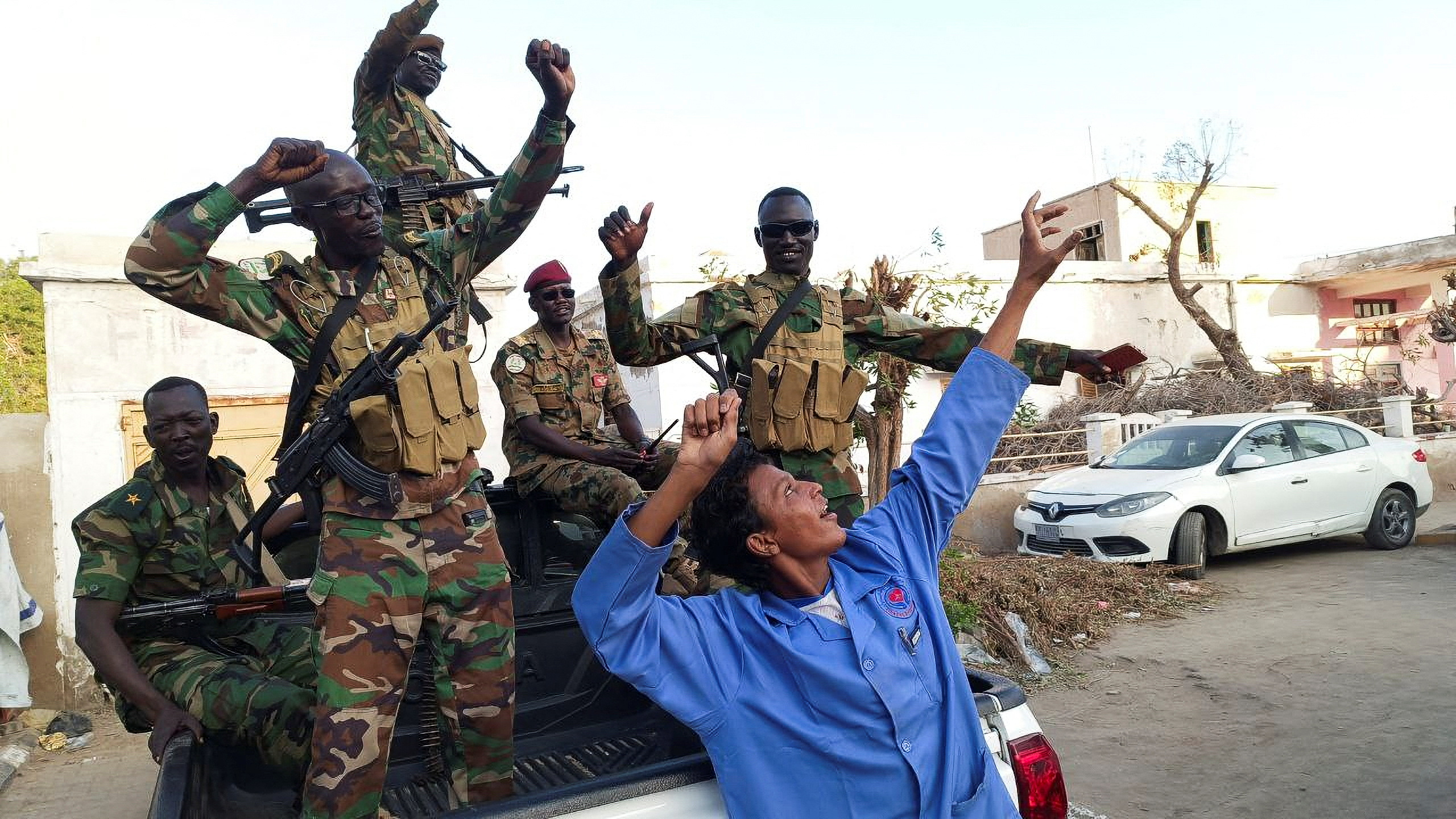 Sudanese citizens celebrate following an announcement by the army that it took over the city of Wad Madani, in Port Sudan