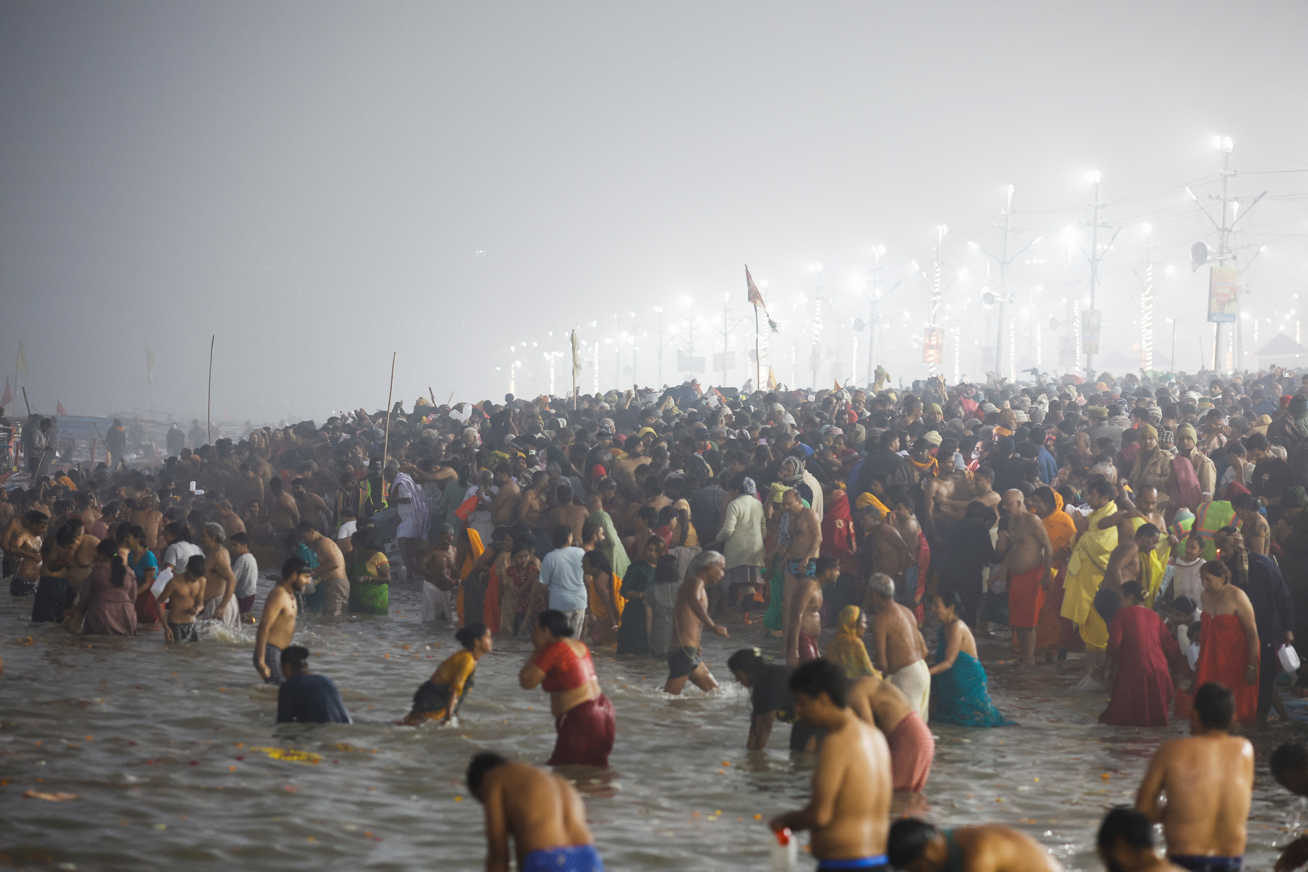Devotees take a holy dip at Sangam, the confluence of the Ganges, Yamuna and Saraswati rivers, during the "Maha Kumbh Mela", or the Great Pitcher Festival, in Prayagraj, India, January 13, 2025