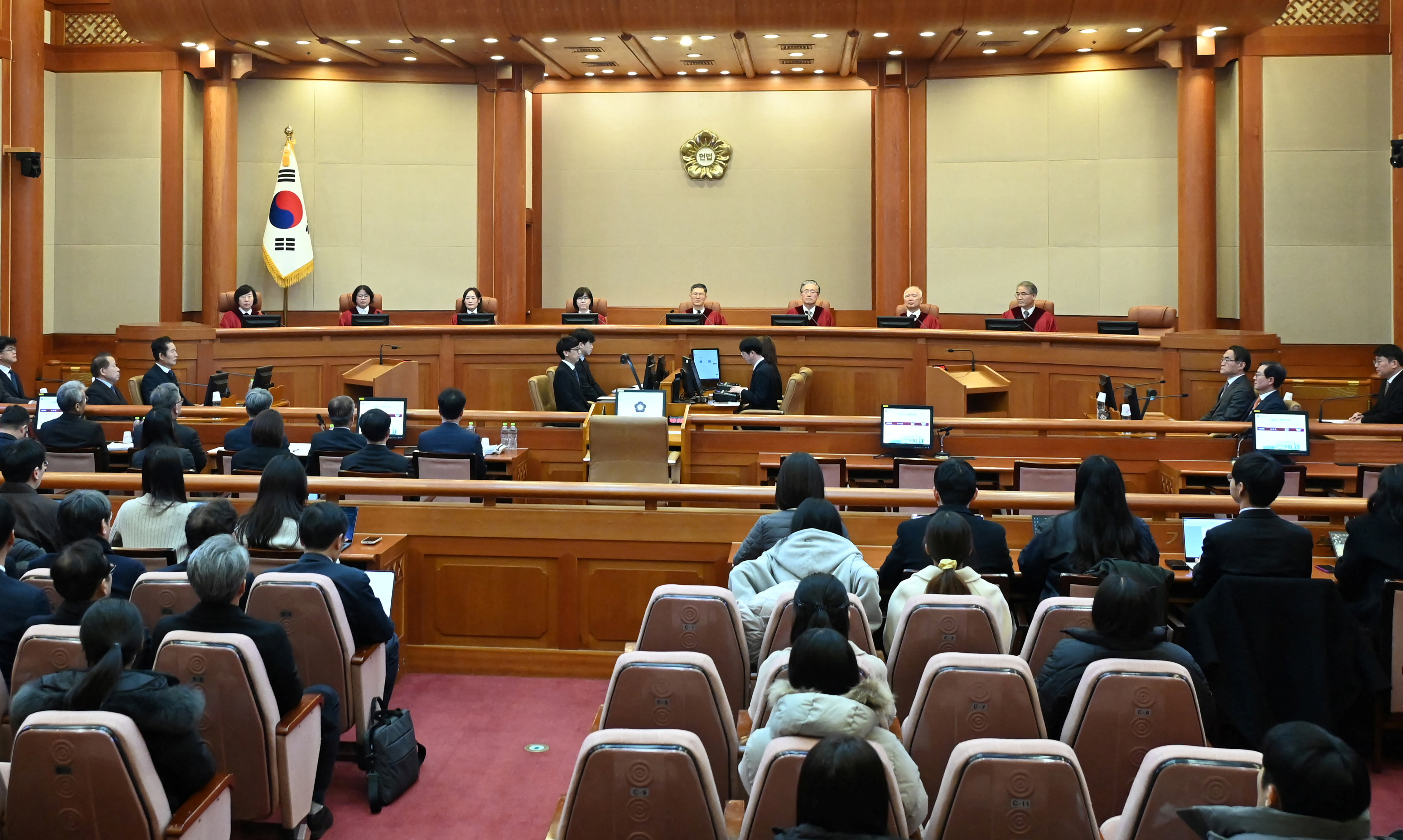 Constitutional Court's Judge Chung Kye-sun, Kim Bok-hyeong, Jung Jung-mi, Lee Mi-son, acting head of the Constitutional Court Moon Hyung-bae and judge Kim Hyung-du, Cheong Hyung-sik and Cho Han-chang sit for the first formal hearing of a trial on the validity of President Yoon Suk Yeol's impeachment by the National Assembly at the constitutional court of Korea on January 14, 2025 in Seoul, South Korea