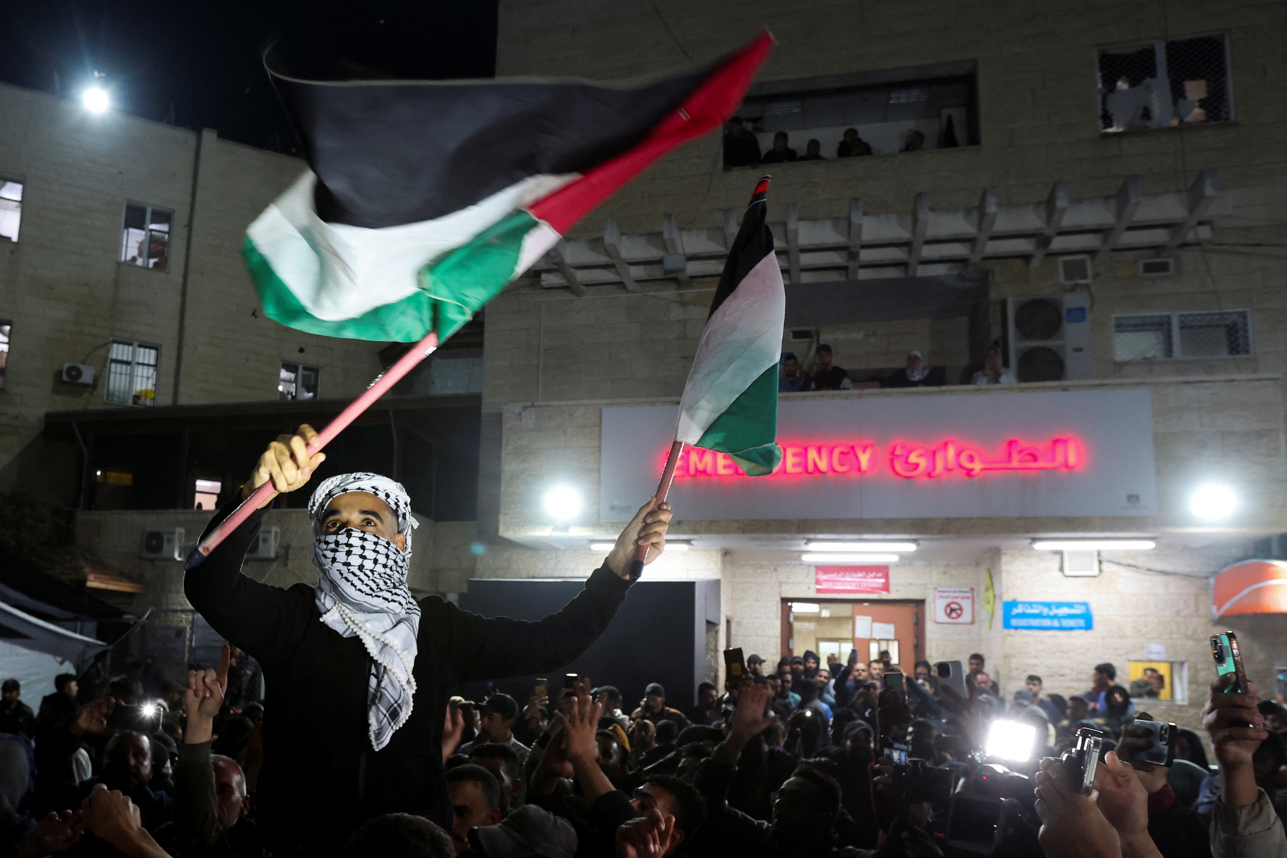 A man waves Palestinian flags.