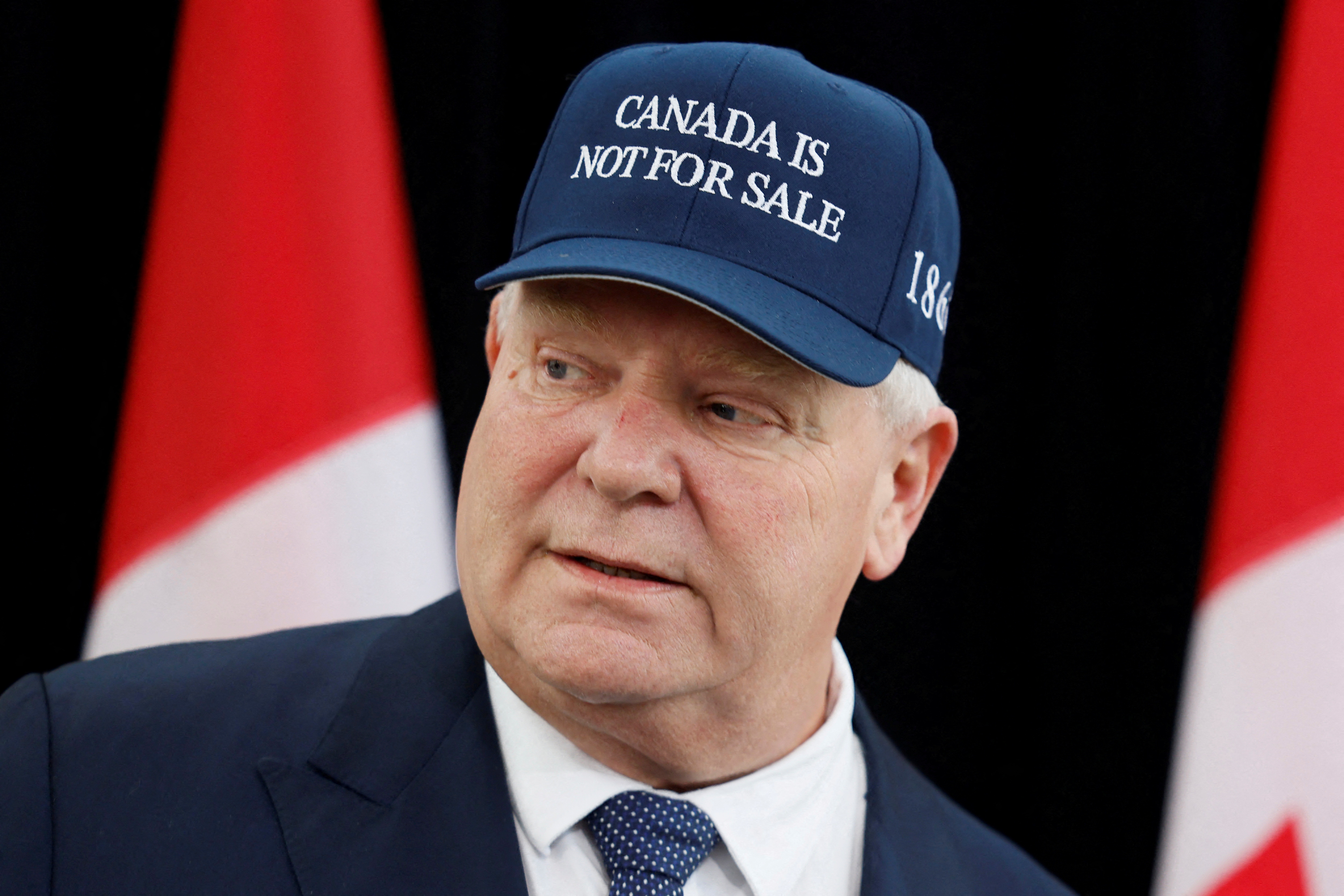 Doug Ford in a blue "Canada is not for sale" baseball cap.