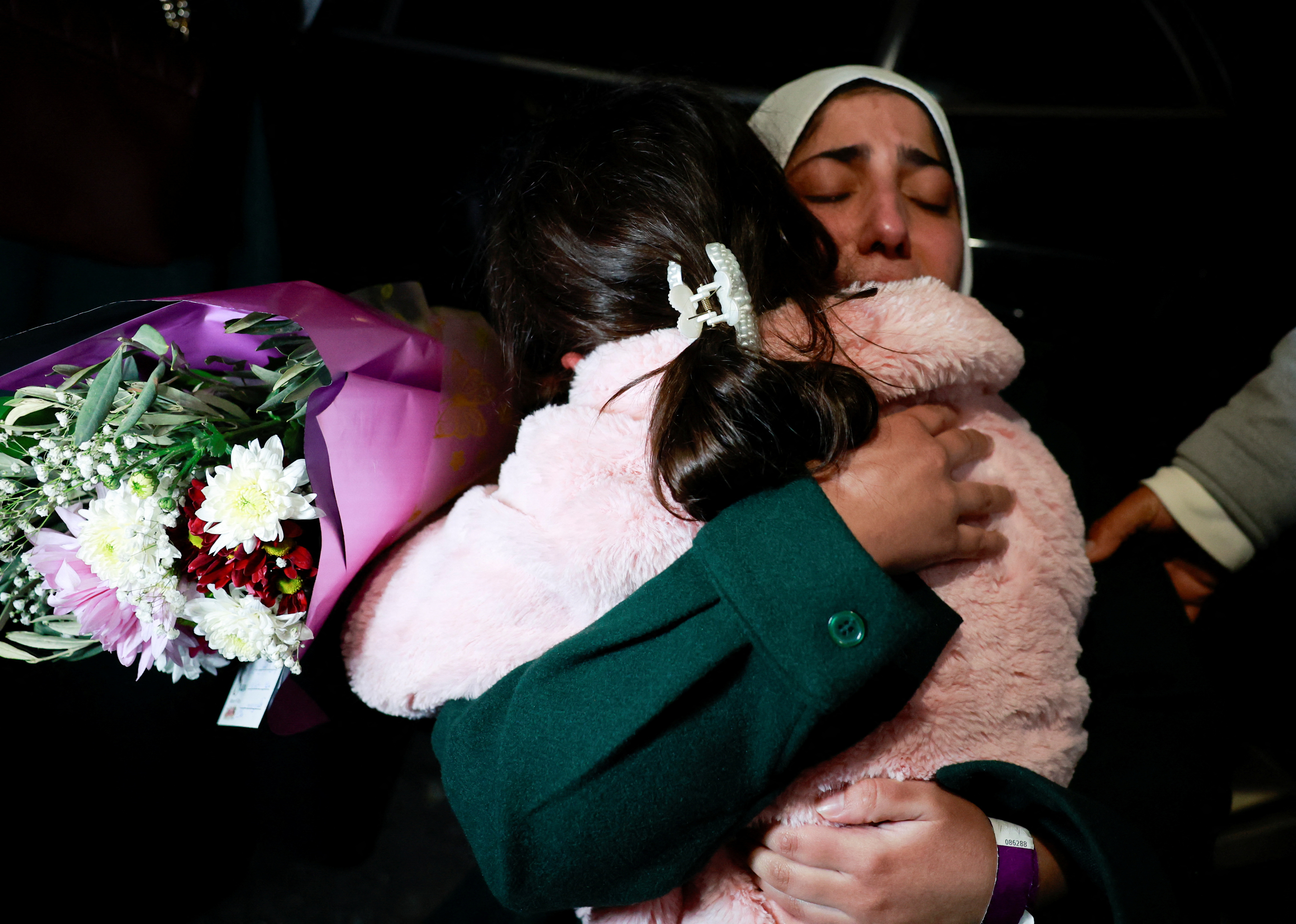 A freed Palestinian prisoner greets her child after her release from an Israeli jail as part of a hostages-prisoners swap and a ceasefire deal in Gaza between Hamas and Israel, in Ramallah, in the Israeli-occupied West Bank, January 20, 2025.