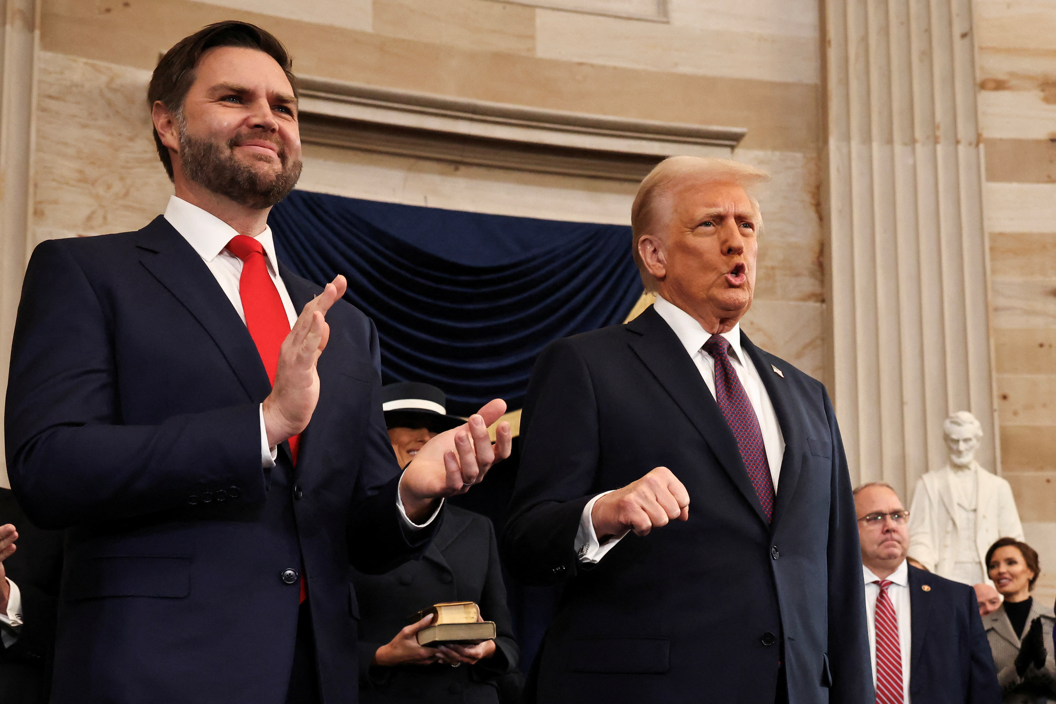 JD Vance and Donald Trump applaud in the Capitol Rotunda.