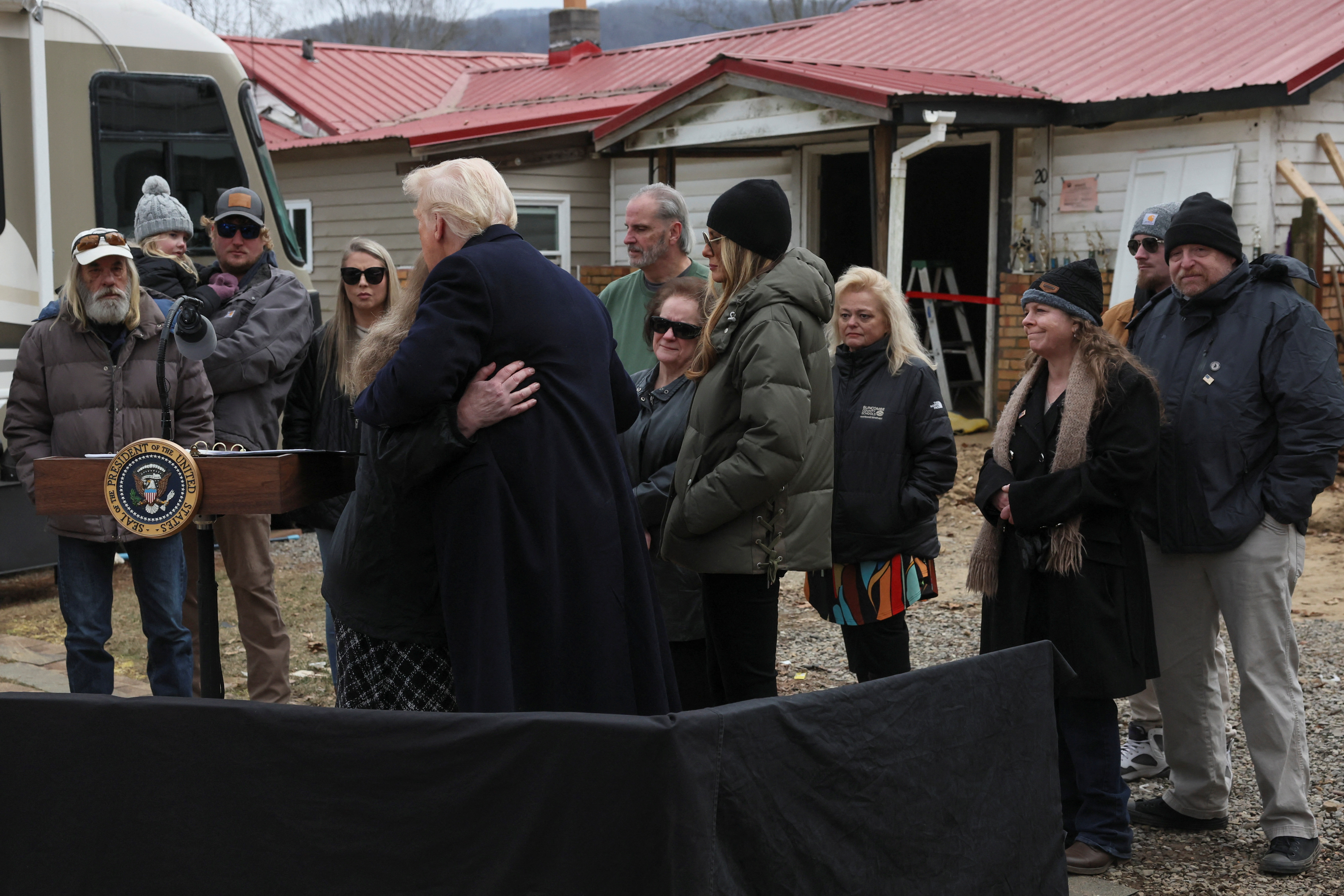 Trump hugs a woman affected by Hurricane Helene in Swannanoa