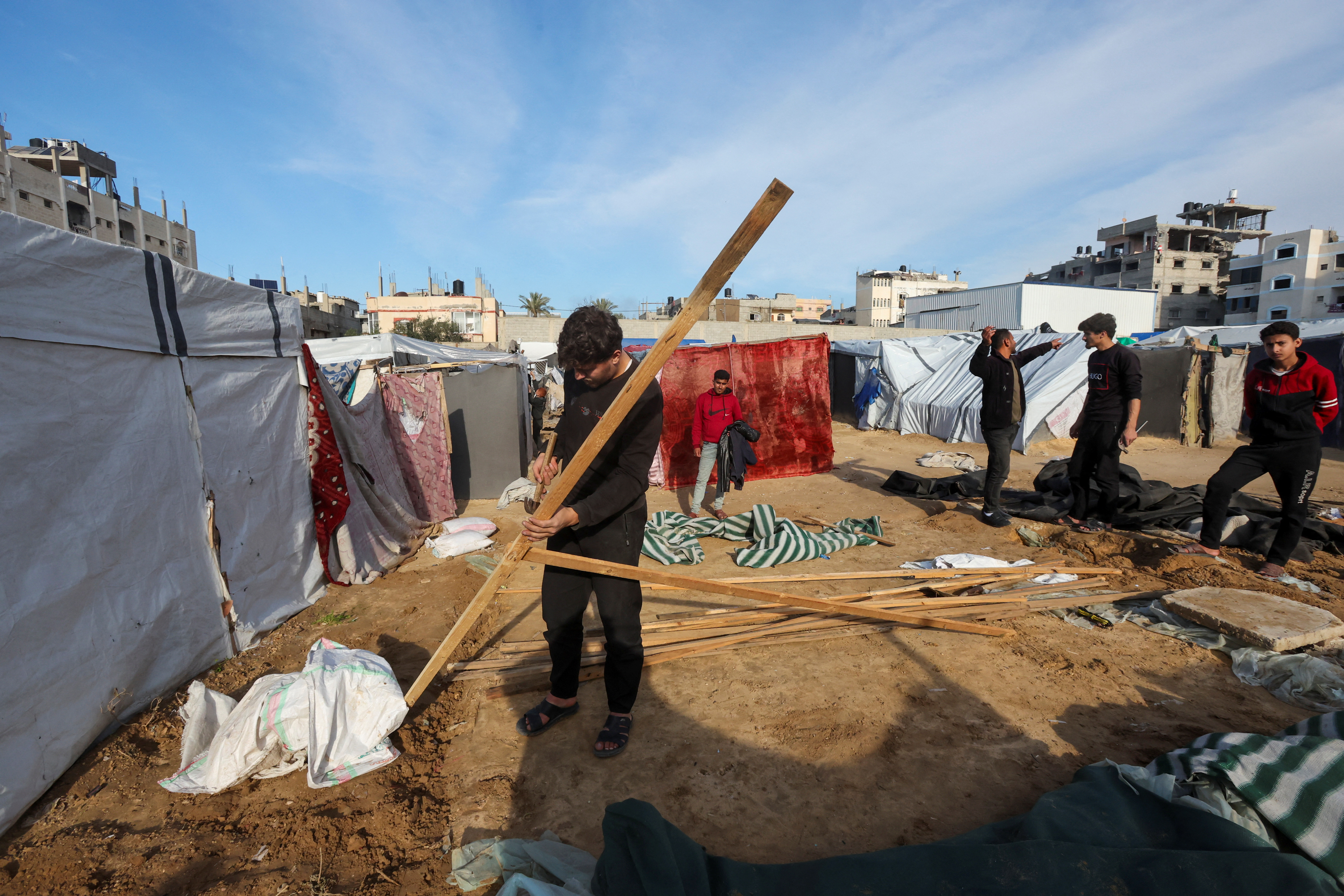 Palestinians, displaced by Israel's order into southern Gaza during the war, dismantle their tent as they wait to be allowed to return to their home in northern Gaza in Deir el-Balah in the central Gaza Strip, January 25, 2025. [Ramadan Abed/Reuters]