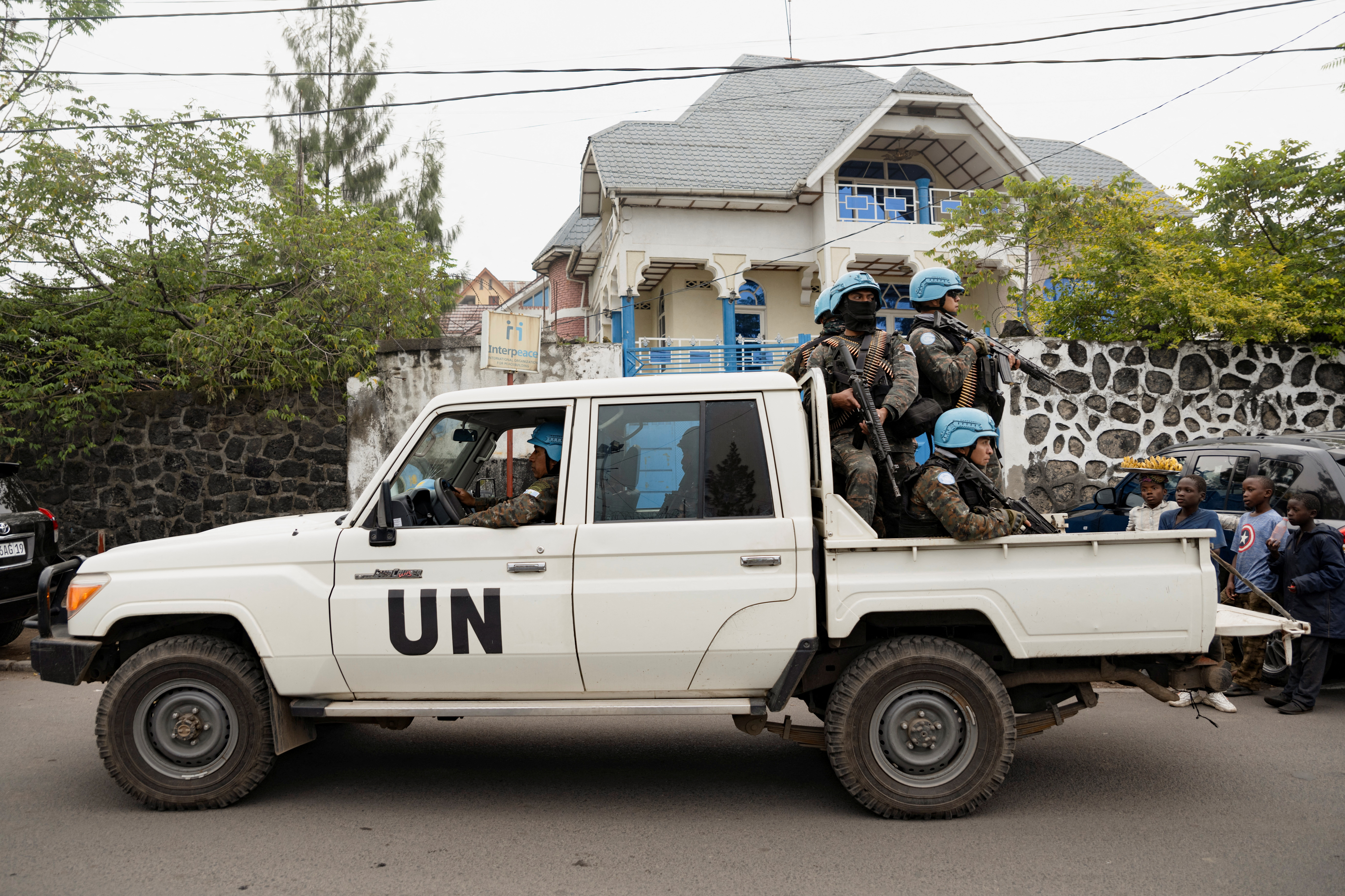 Members of MONUSCO ride on a pickup truck as they secure the evacuation of non-essential UN staff in Goma, North Kivu, DRC