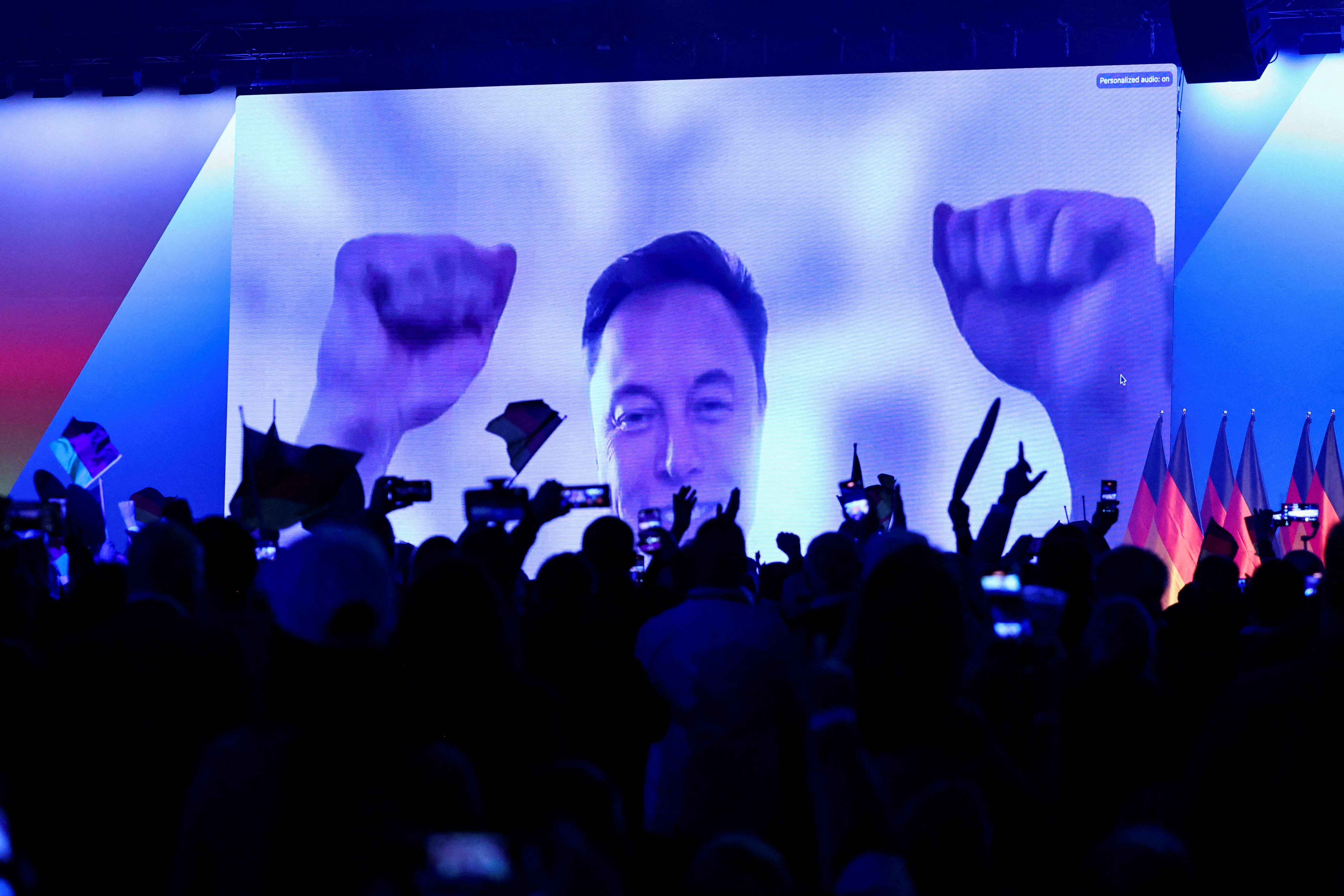SpaceX CEO Elon Musk gestures as he speaks on-screen.