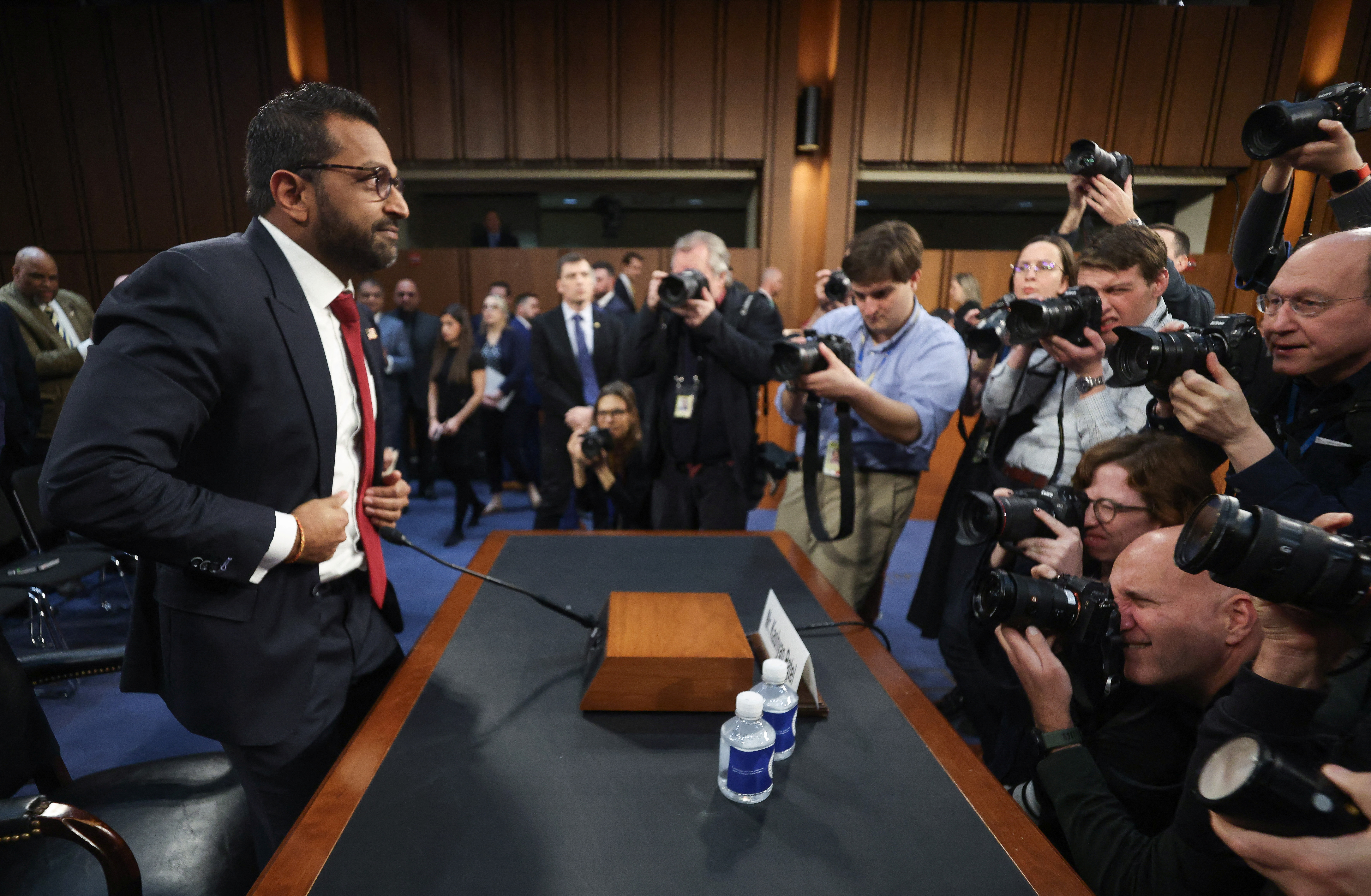 Kash Patel faces a crowd of journalists at his Senate hearing