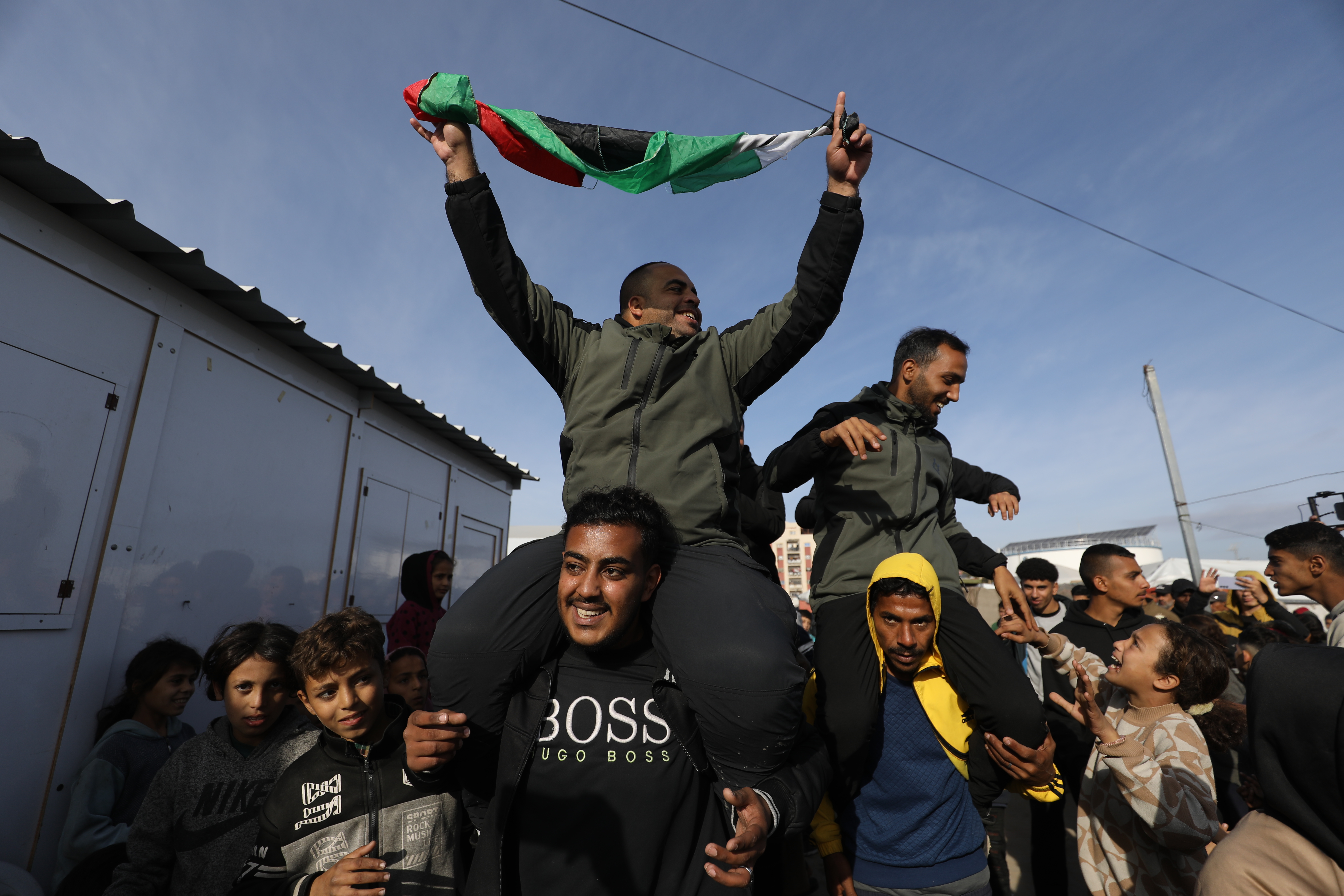 Palestinians celebrate the ceasefire announcement