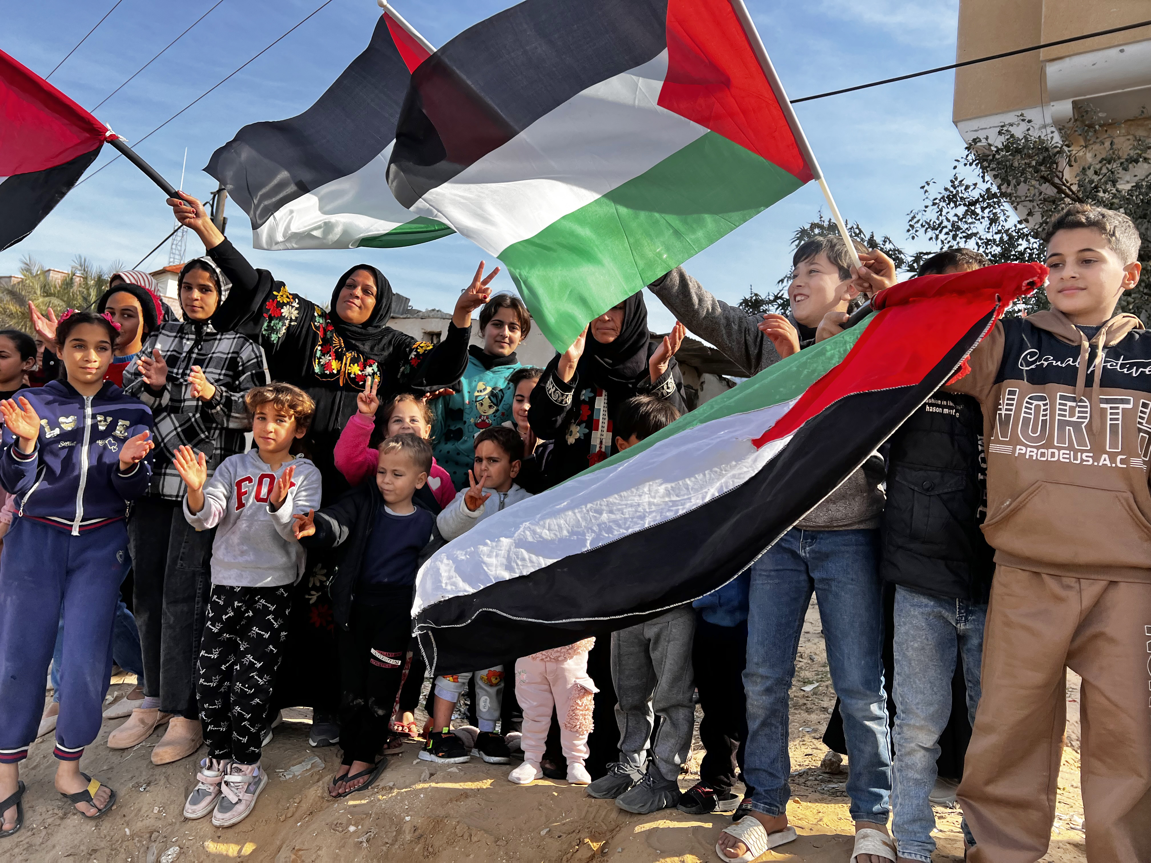 Palestinians celebrate the ceasefire announcement