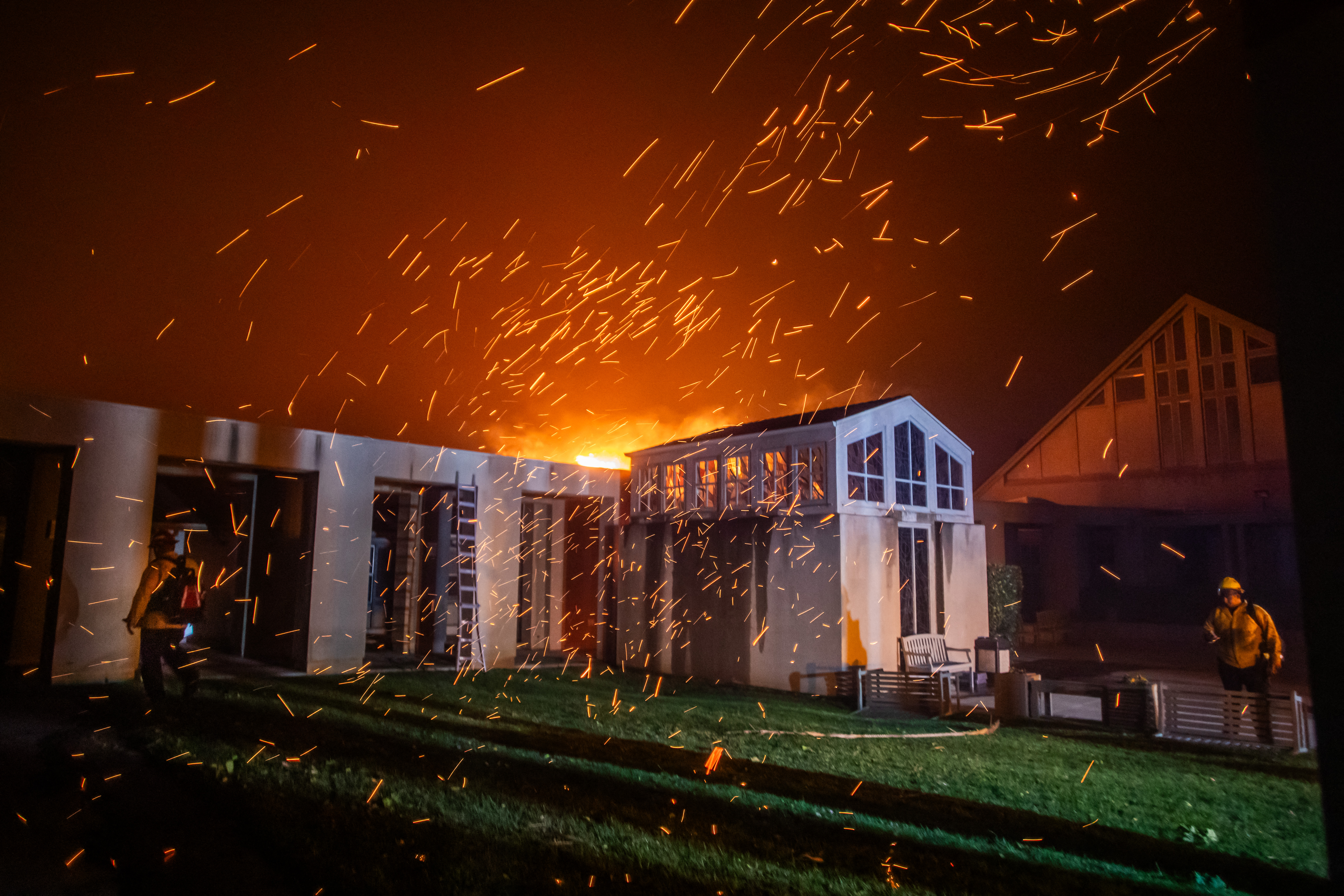 A Firefighter watches the flames from the Palisades Fire burning in front of the Pacific Palisades Presbyterian Church during a powerful windstorm on January 8