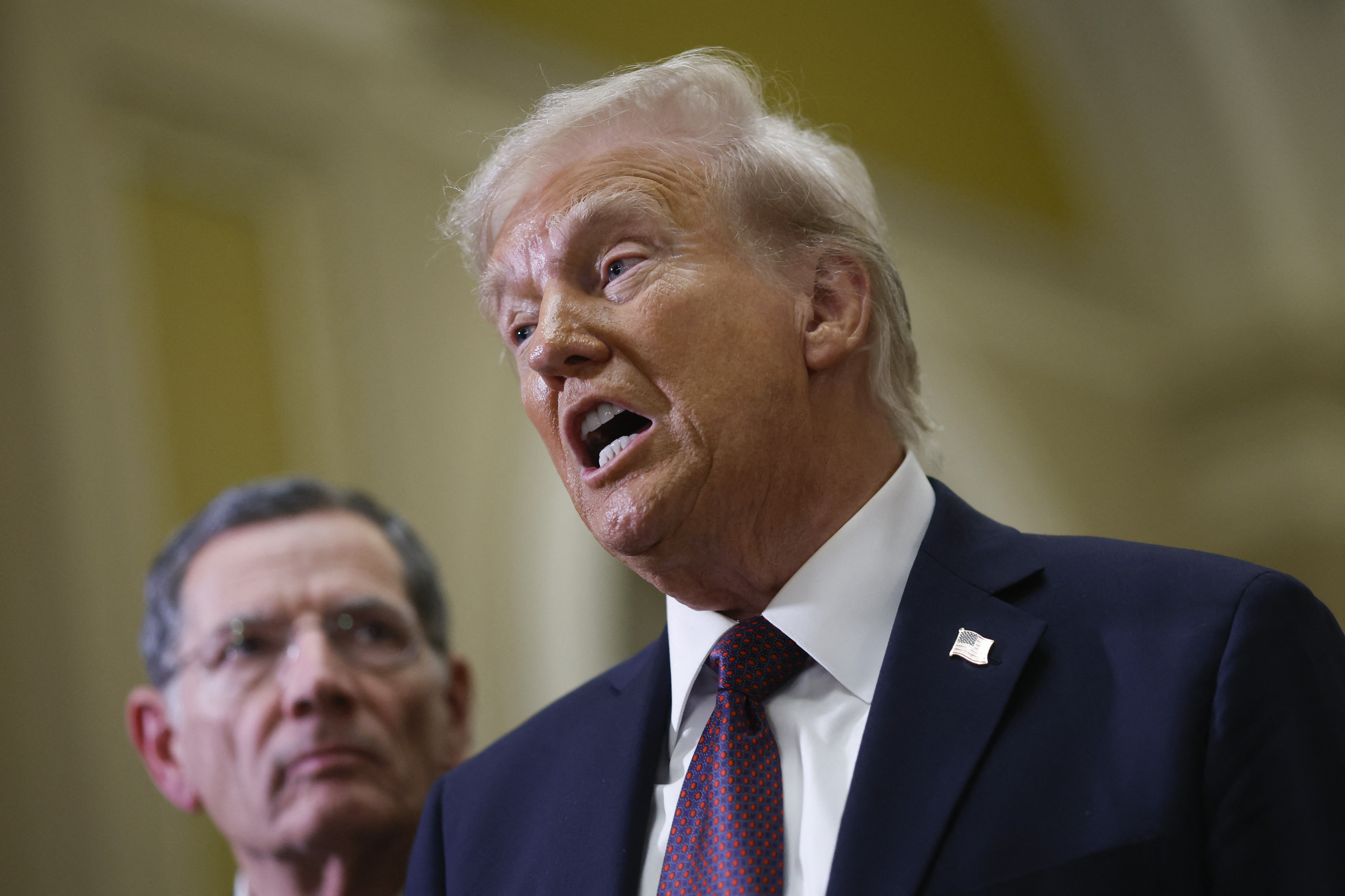 US Senator John Barrasso (R-WY) watches US President-elect Donald Trump speak to the press after paying their respects in front of the flag-draped casket at the Lying in State Ceremony for former President Jimmy Carter at the US Capitol Rotunda in Washington, DC on January 8, 2025. Carter, the 39th President of the United States, died at the age of 100 on December 29, 2024 at his home in Plains, Georgia. (Photo by Ting Shen / AFP)