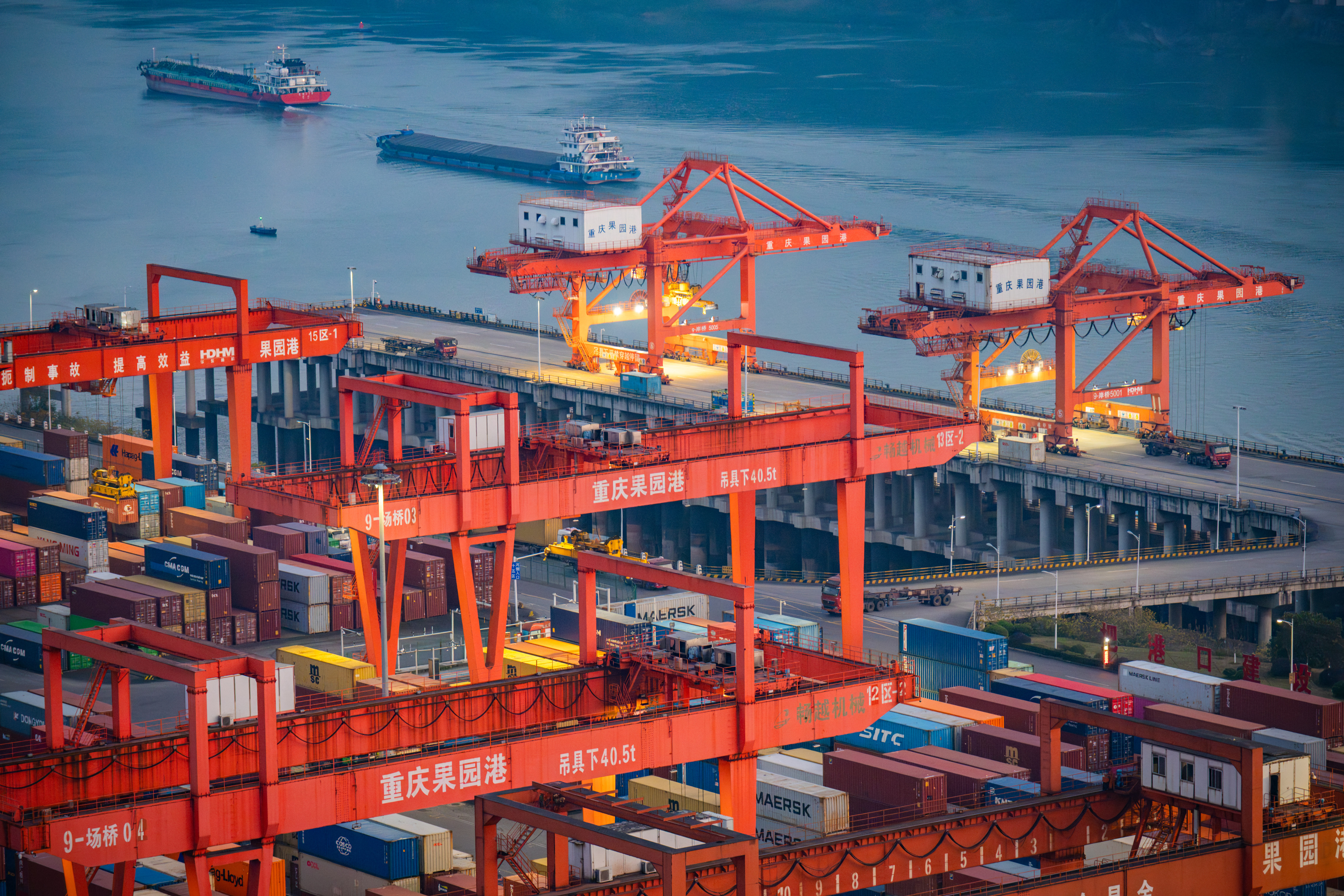 Cargo ships passing containers at port.