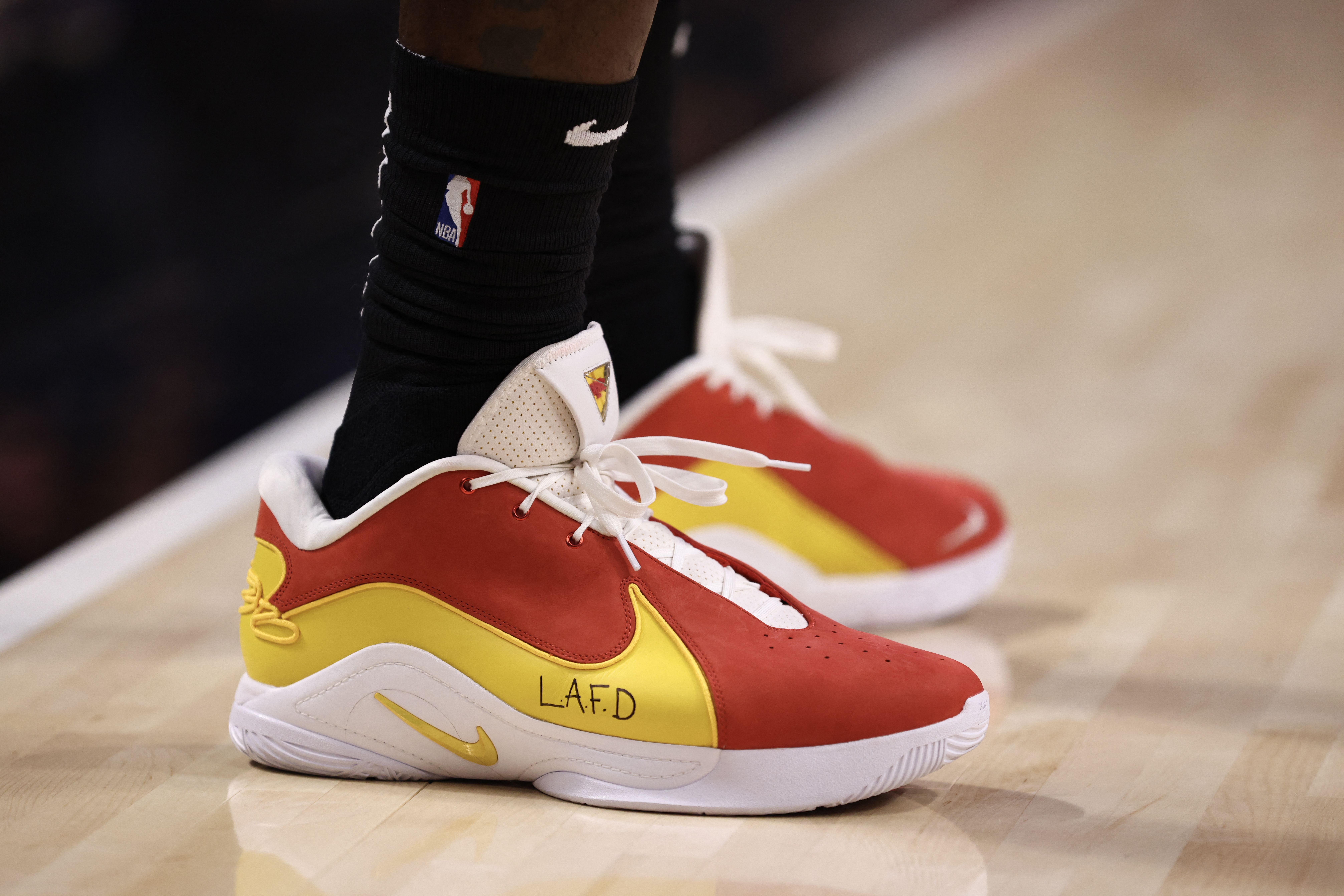 LOS ANGELES, CALIFORNIA - JANUARY 13: A detail view of the shoes worn by LeBron James #23 of the Los Angeles Lakers showing support for the LA Fire Department during the first quarter against the San Antonio Spurs at Crypto.com Arena on January 13, 2025 in Los Angeles, California. NOTE TO USER: User expressly acknowledges and agrees that, by downloading and/or using this Photograph, user is consenting to the terms and conditions of the Getty Images License Agreement. Katelyn Mulcahy/Getty Images/AFP (Photo by Katelyn Mulcahy / GETTY IMAGES NORTH AMERICA / Getty Images via AFP)