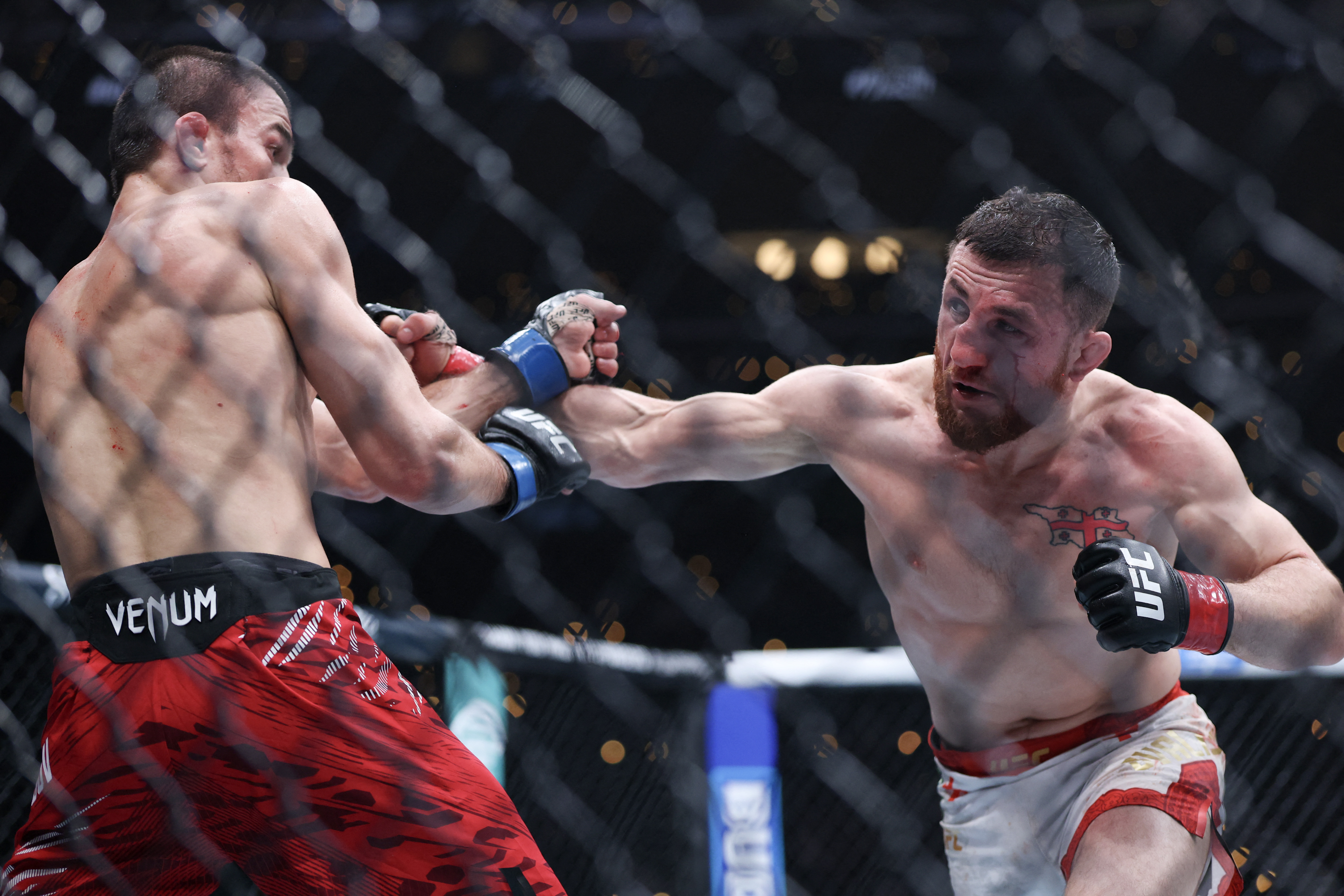 INGLEWOOD, CALIFORNIA - JANUARY 18: Merab Dvalishvili of Georgia punches Umar Nurmagomedov of Russia in a bantamweight title fight during UFC 311 at Intuit Dome on January 18, 2025 in Inglewood, California. Harry How/Getty Images/AFP (Photo by Harry How / GETTY IMAGES NORTH AMERICA / Getty Images via AFP)