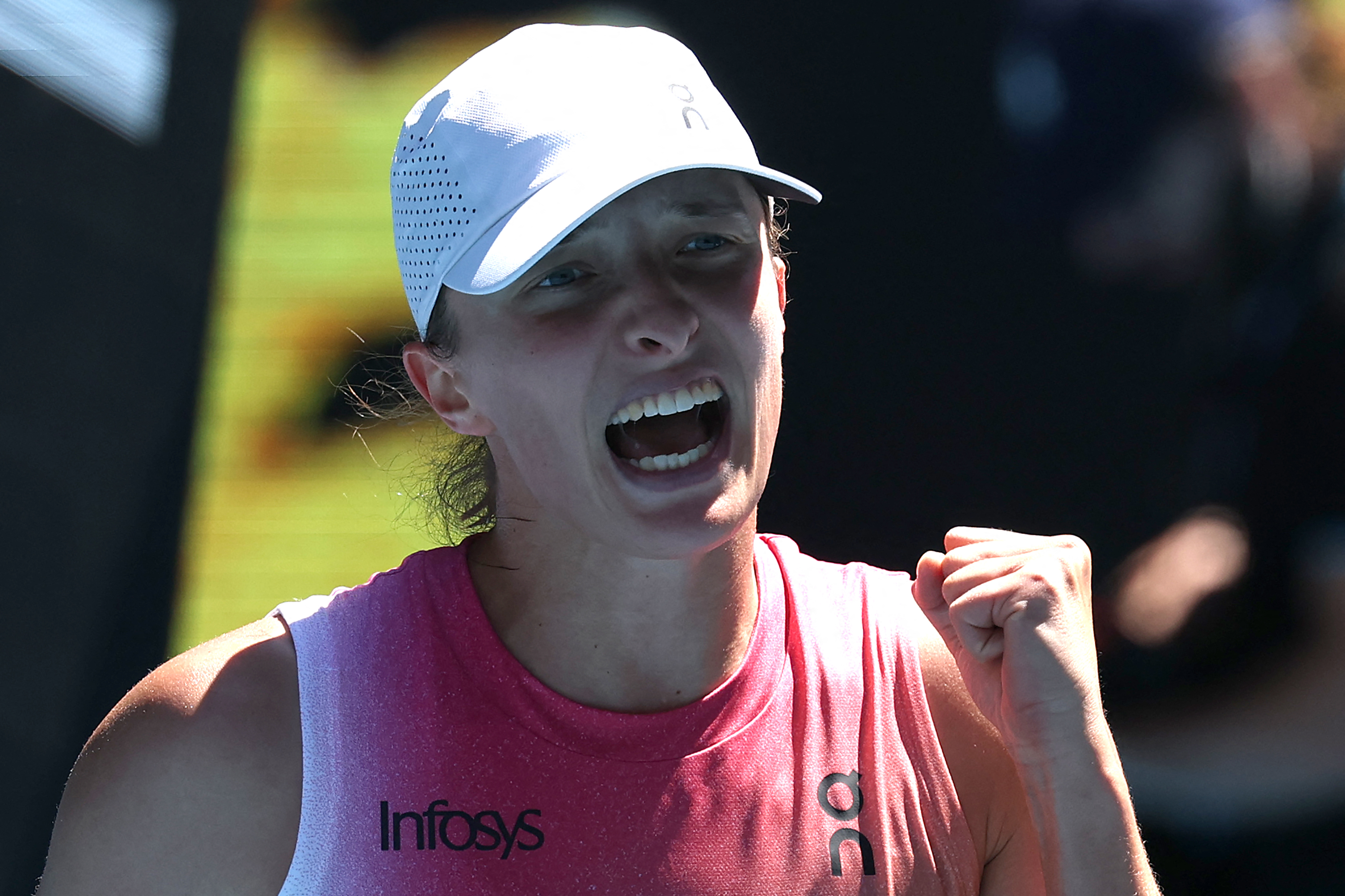 Poland's Iga Swiatek celebrates victory over USA's Emma Navarro after their women's singles quarter-final match on day eleven of the Australian Open tennis tournament in Melbourne on January 22, 2025. (Photo by DAVID GRAY / AFP) / -- IMAGE RESTRICTED TO EDITORIAL USE - STRICTLY NO COMMERCIAL USE --