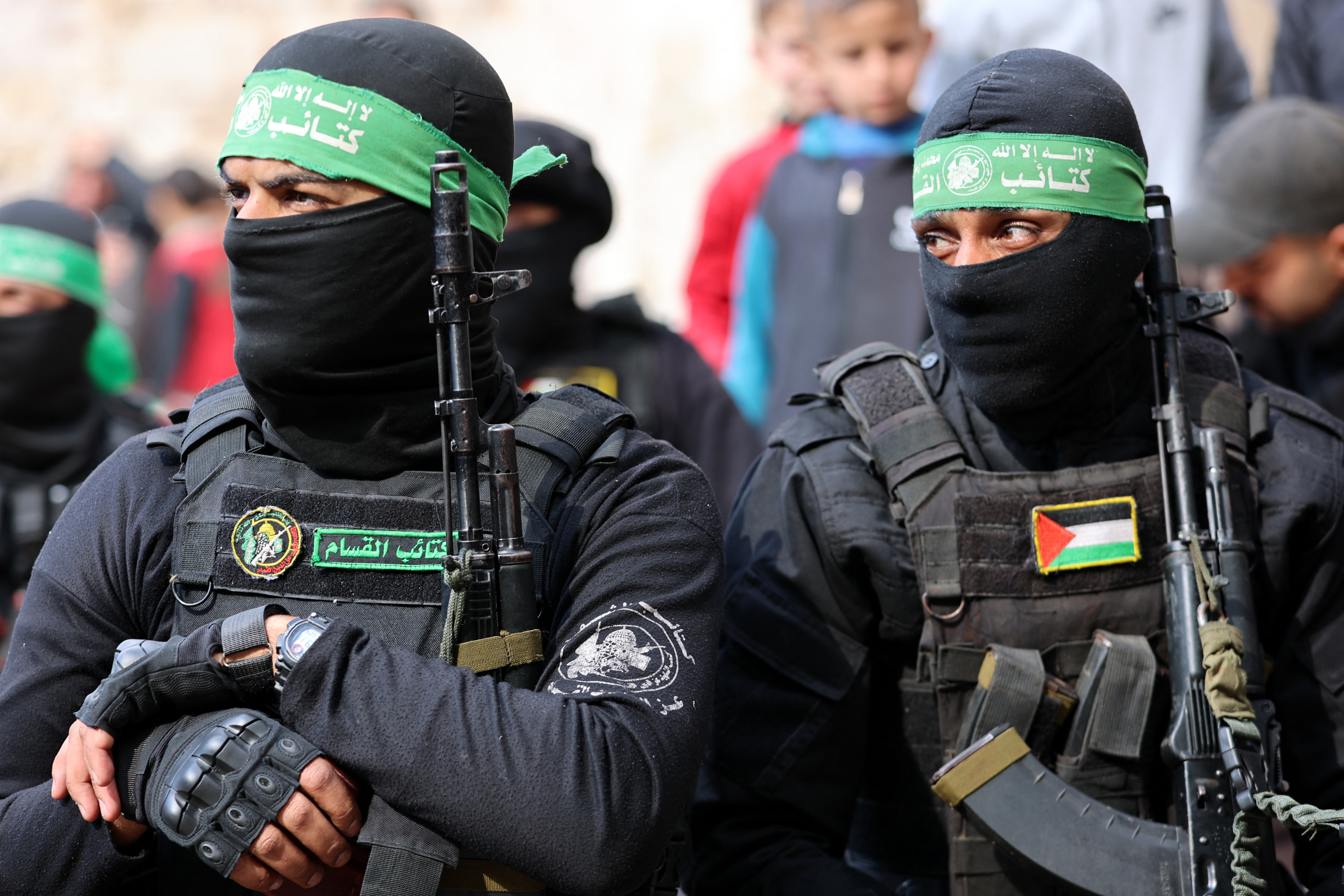 Fighters of the Ezzedine al-Qassam Brigades, Hamas's armed wing, attend the funeral of two fighters in Gaza City on January 24, 2025, after a ceasefire deal in the war between Israel and Hamas in the coastal Palestinian territory. A senior Hamas official told AFP that his group will provide on January 24, the names of four Israeli women hostages to be freed the following day as part of a second release under the ceasefire with Israel. The truce, the second in the more than 15 months of war, began on January 19, with the first three hostages released in exchange for around 90 Palestinian prisoners. (Photo by Omar AL-QATTAA / AFP)