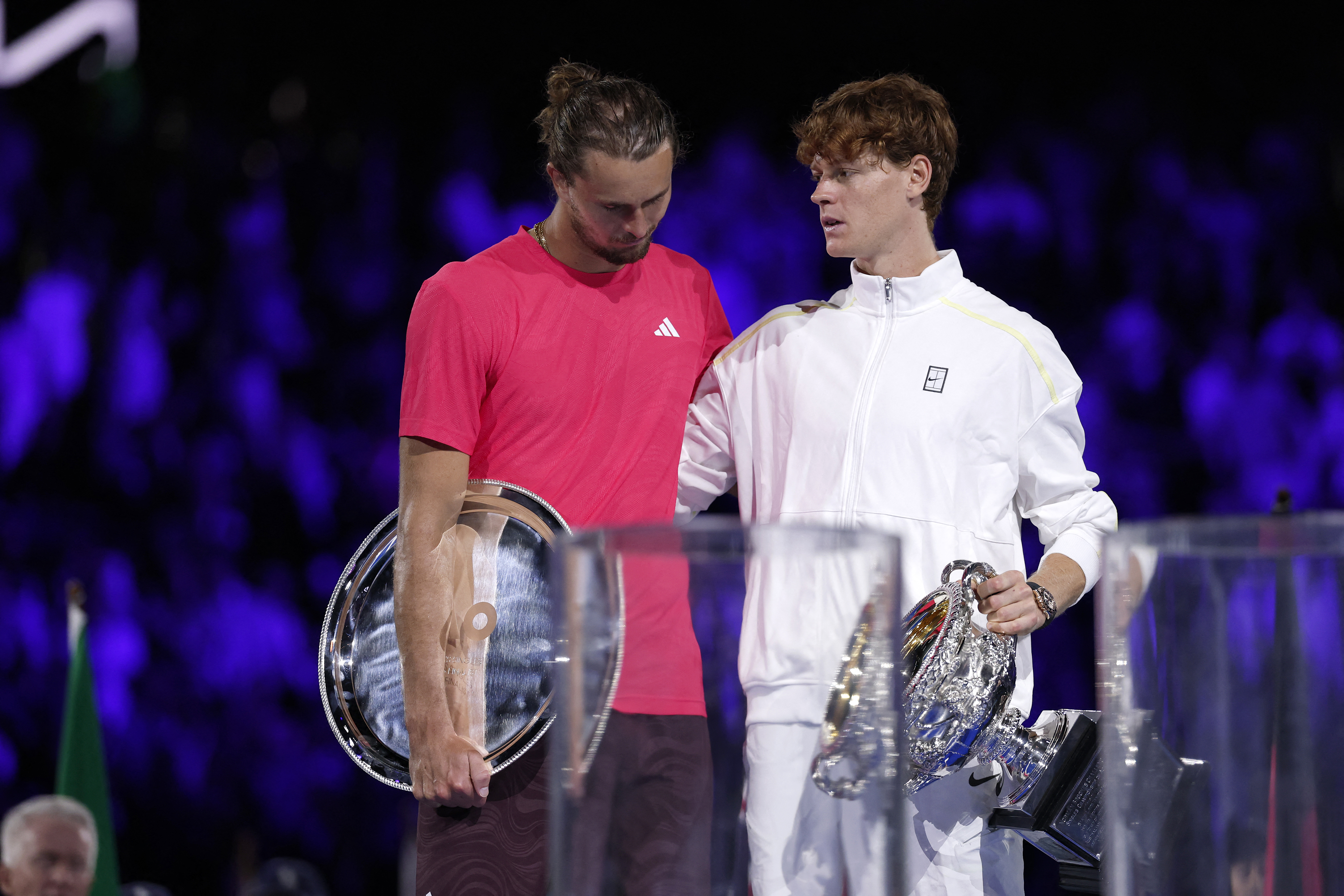 Italy's Jannik Sinner (R) and runners up Germany's Alexander Zverev pose for pictures after their men's singles final match on day fifteen of the Australian Open tennis tournament in Melbourne on January 26, 2025. (Photo by Martin KEEP / AFP) / -- IMAGE RESTRICTED TO EDITORIAL USE - STRICTLY NO COMMERCIAL USE --
