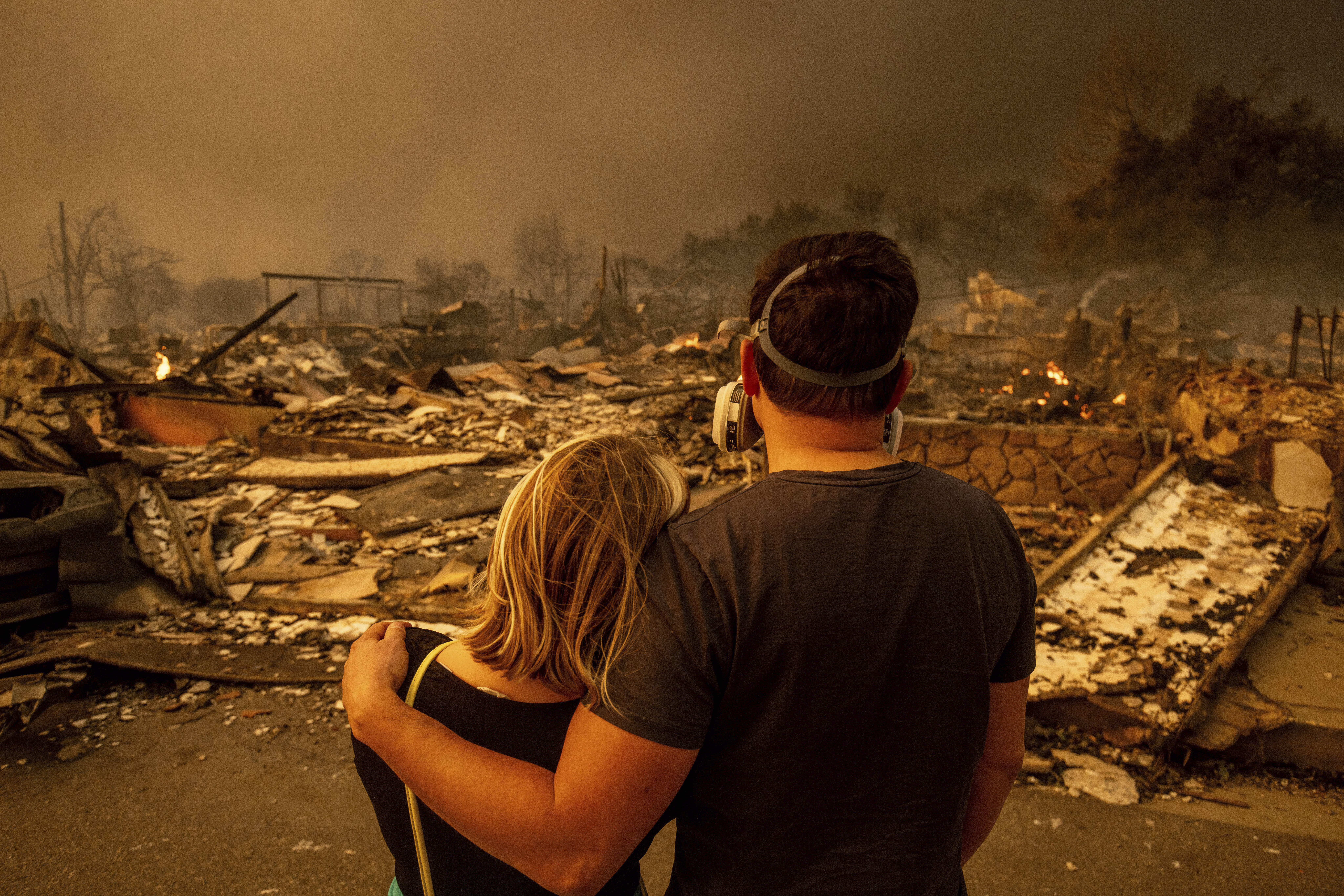 Megan Mantia, left, and her boyfriend Thomas, only first game given, return to Mantia's fire-damaged home after the Eaton Fire swept through the area, Wednesday, Jan. 8