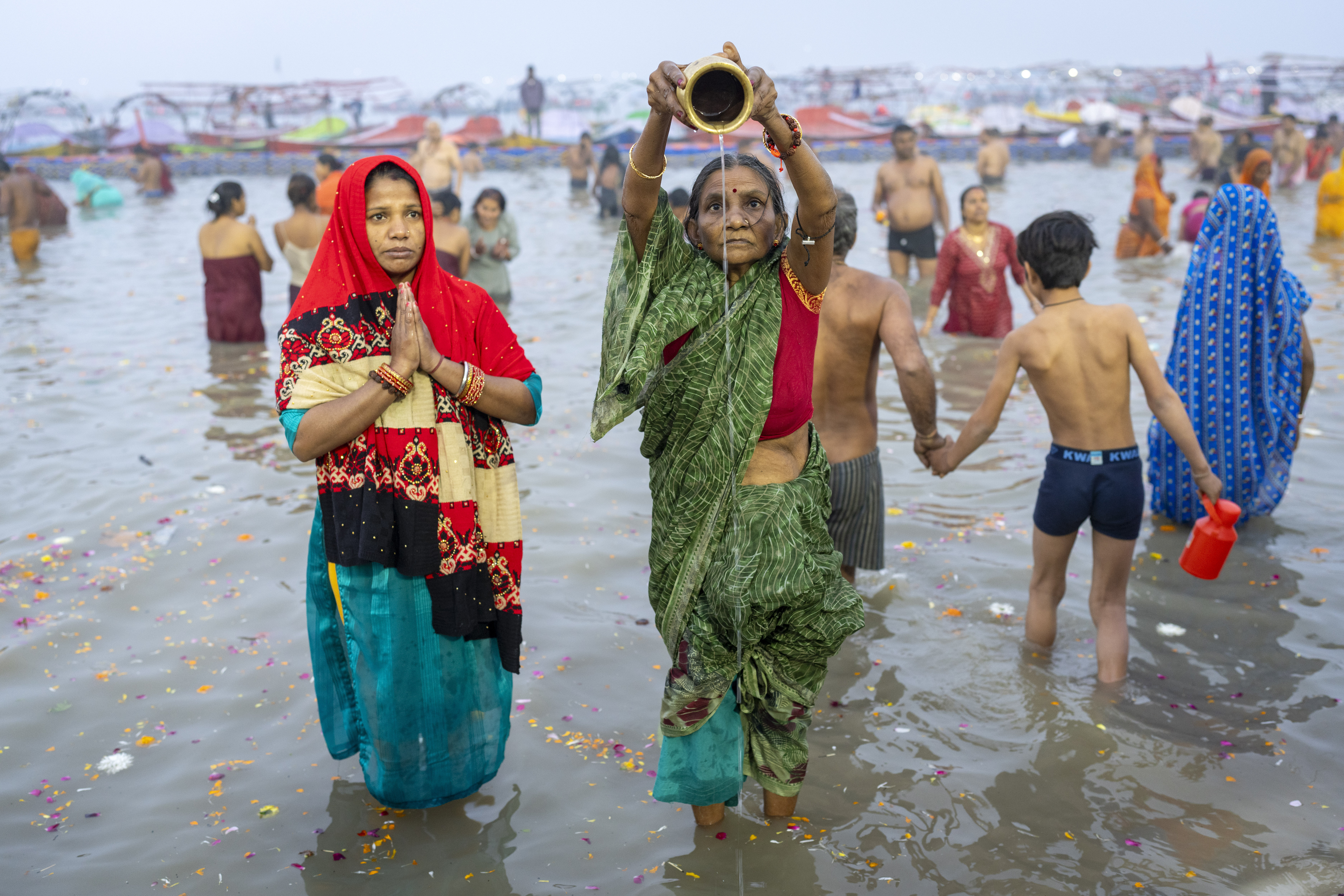 Hindu devotees pray before taking a dip.
