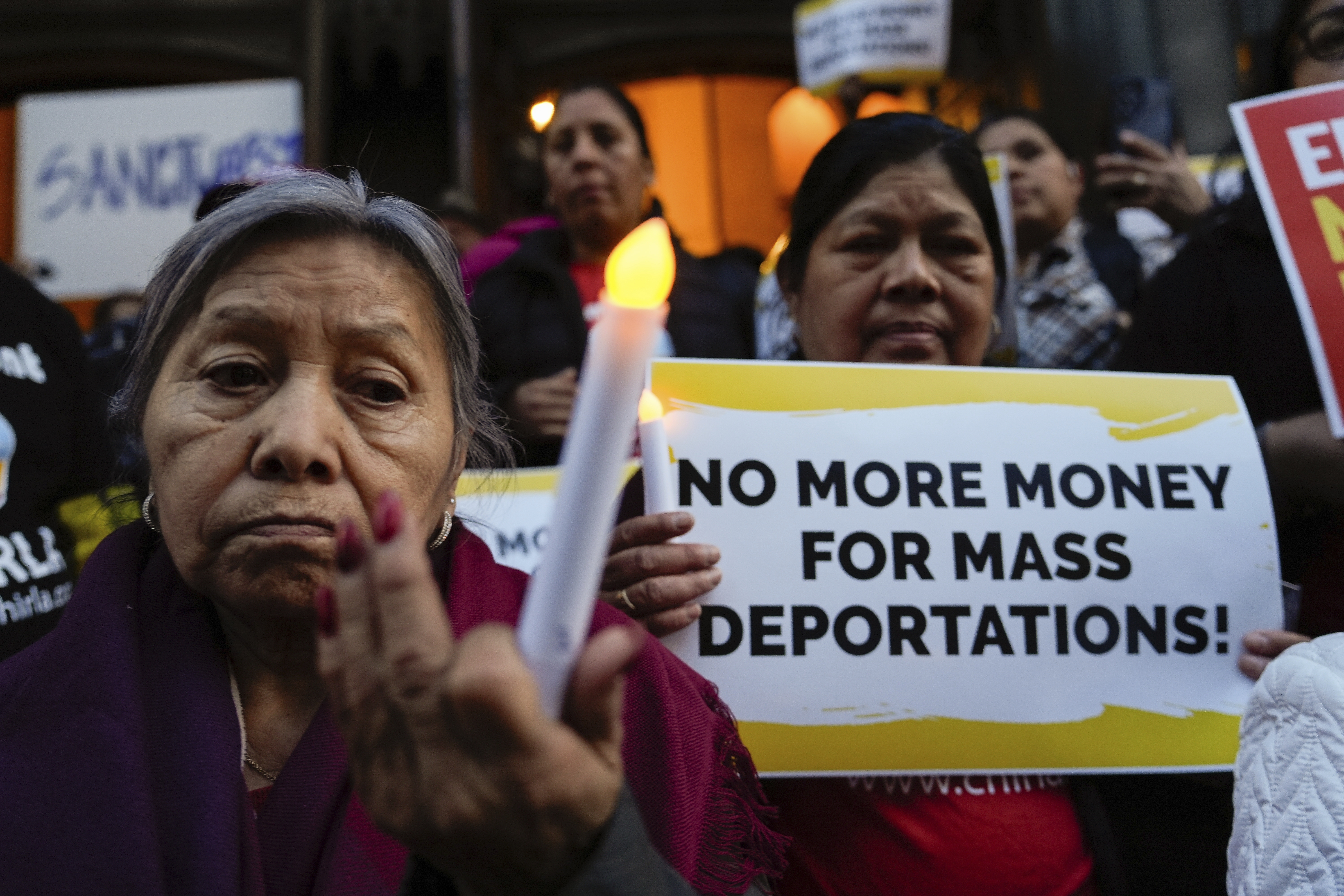 Members of an immigrant community hold a vigil.