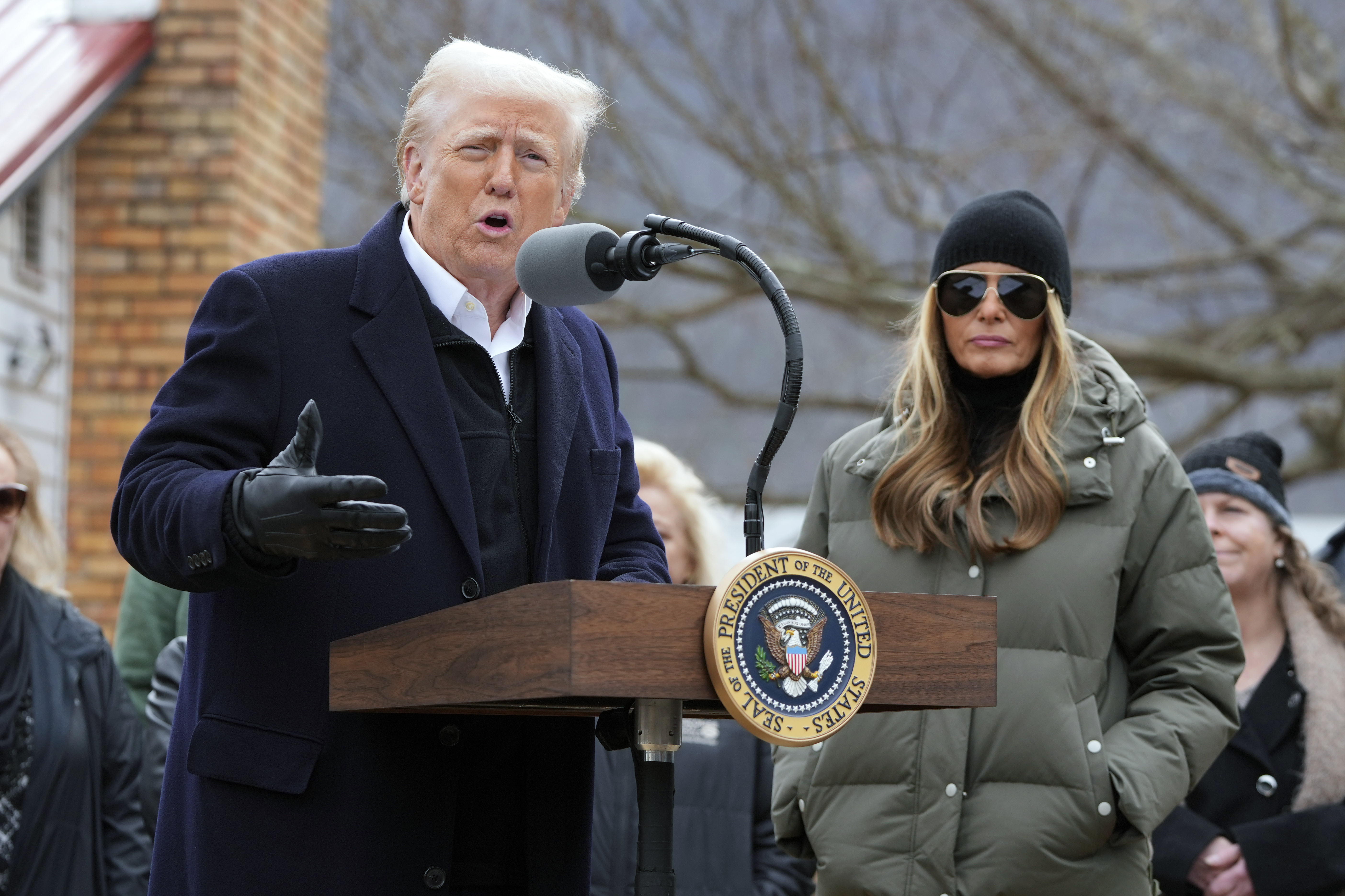 Donald Trump speaks outdoors in North Carolina next to Melania Trump