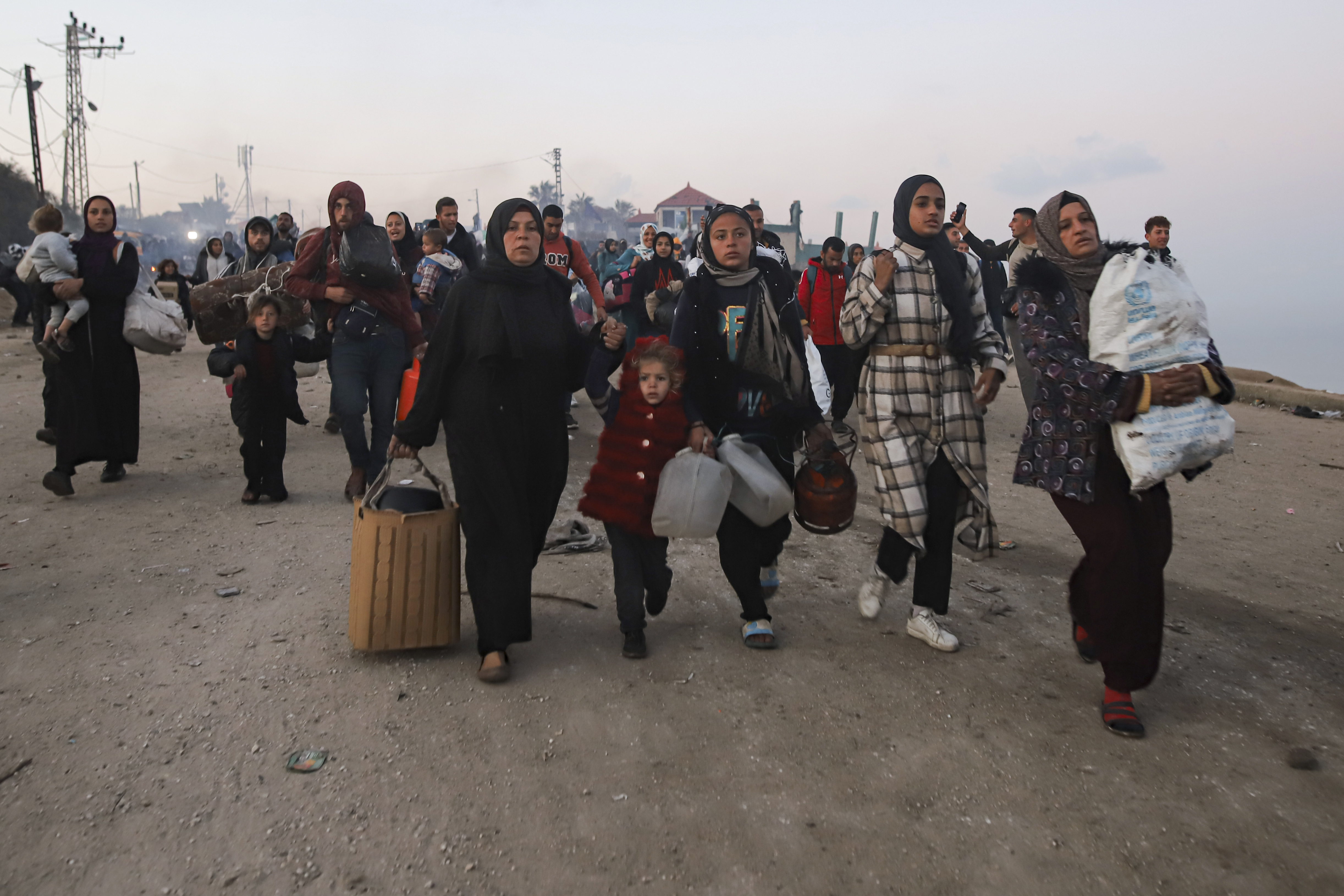Palestinians walk back to their homes in northern Gaza