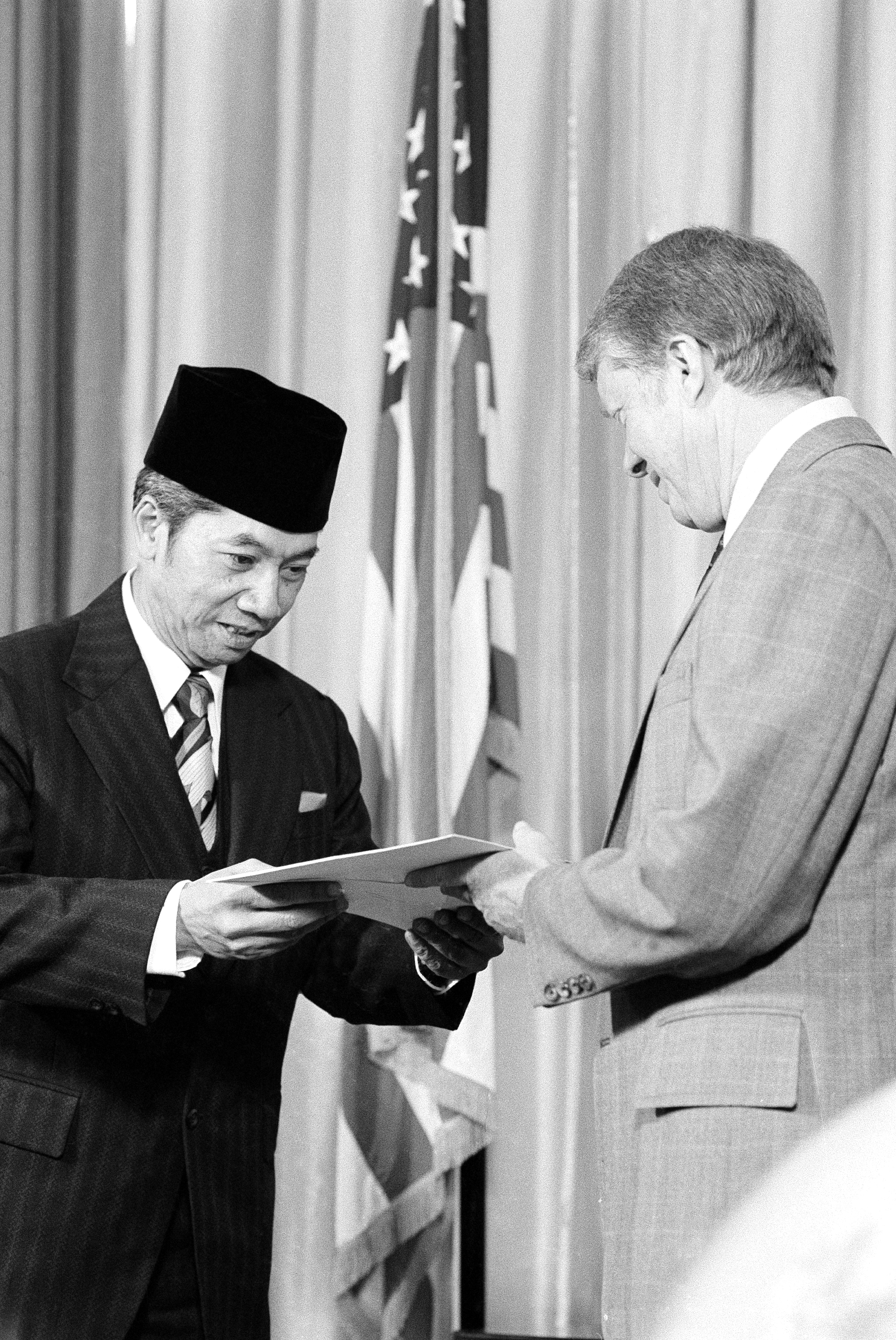 Ambassador Ambari Danudirdjo, of Indonesia, left, presents his credentials to President Jimmy Carter in the Oval Office in Washington on Feb. 15, 1978.